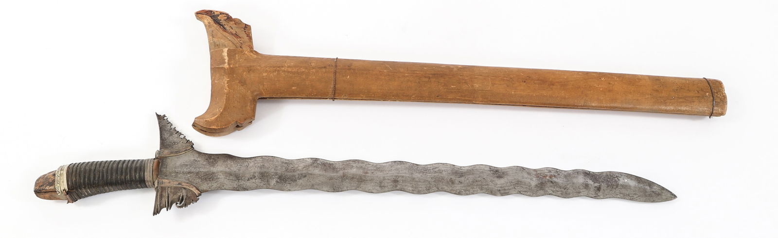 20th C. SOUTHEAST ASIAN KRIS DAGGER: 20th C. SOUTHEAST ASIAN KRIS DAGGER 20th Century Southeast Asian Kris Dagger. Double edged blade. No visible maker marks. Leather wrapped wooden handle with alloy based spacers. Wooden scabbard. Blade