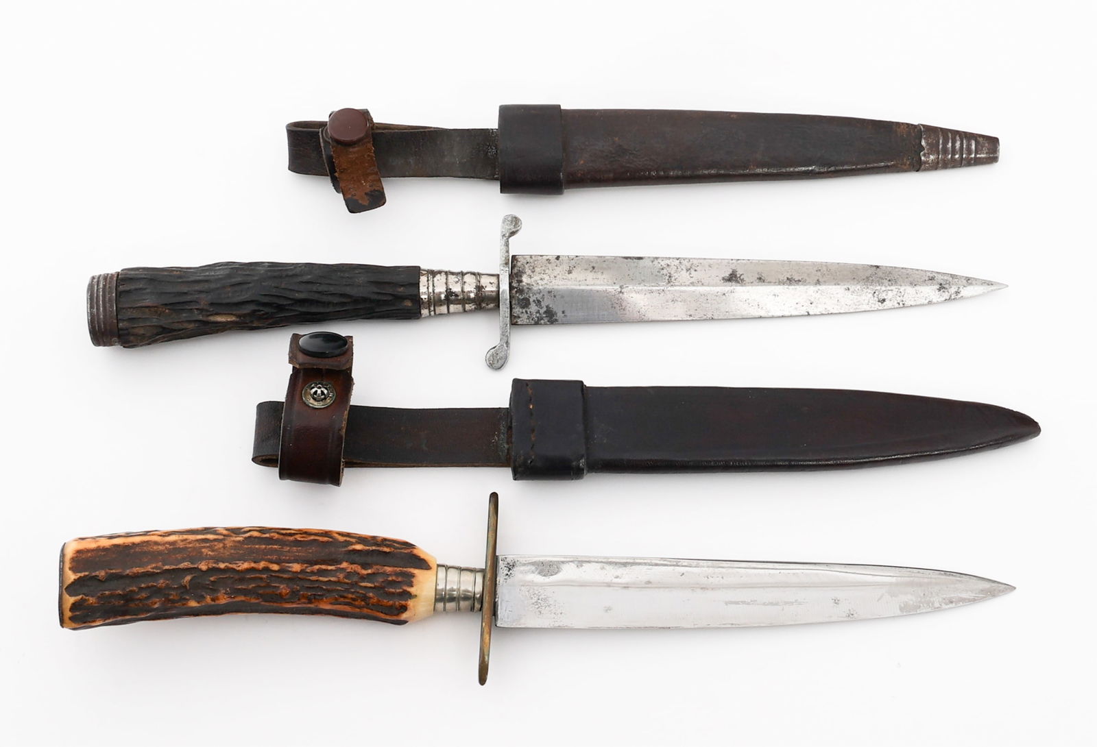 GERMAN STAG HORN HUNTING DAGGERS: GERMAN STAG HORN HUNTING DAGGERS German Stag Horn Hunting Daggers. No visible maker marks. Stag horn handles. Both have leather sheaths. Blade Length: 6" to 6 1/4" Total Length: 10 5/8" to 11 1/4" Pro