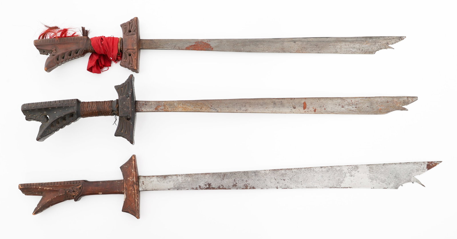 SOUTHEAST ASIAN KAMPALIN SWORDS: SOUTHEAST ASIAN KAMPALIN SWORDS Southeast Asian Kampalin Swords. (3) Single edged blades with wood hilts. One has red cloth and animal hair on the hilt. No scabbards or sheaths. Blade Length: 26 3/4" 
