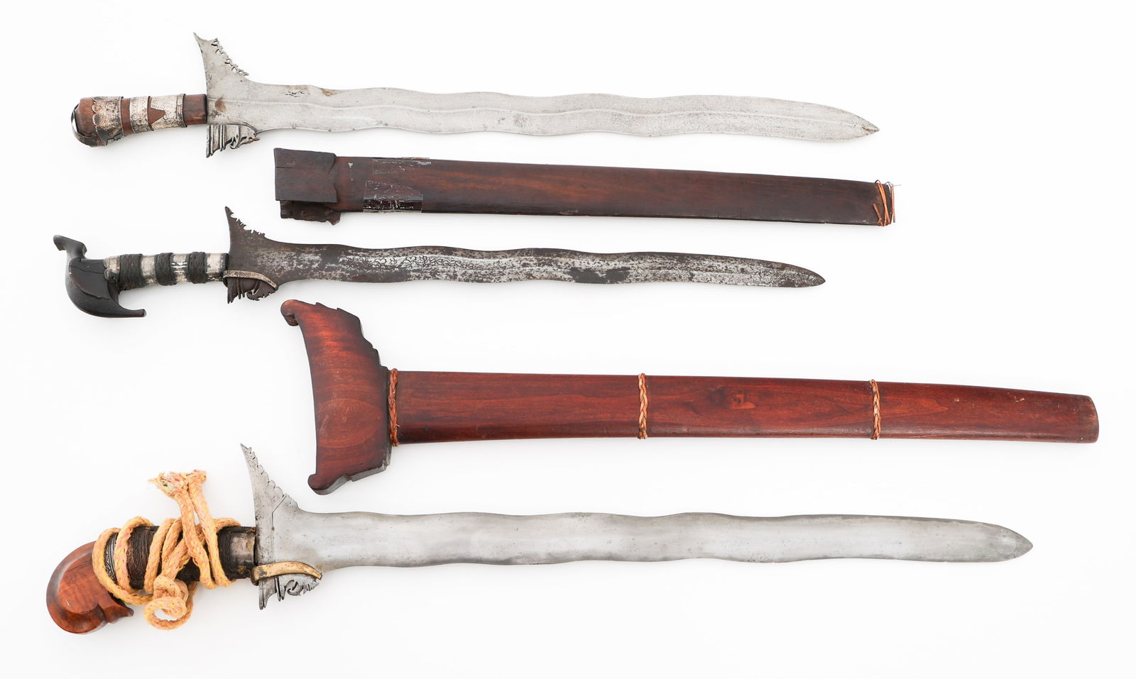 SOUTHEAST ASIAN KRIS DAGGERS: SOUTHEAST ASIAN KRIS DAGGERS Southeast Asian Kris Daggers. (3) Kris Daggers. Double edged, wavy blades with wood, alloy and brass handles. Two scabbards. Blade Length: 19 1/4" to 23 1/4" Total Length: