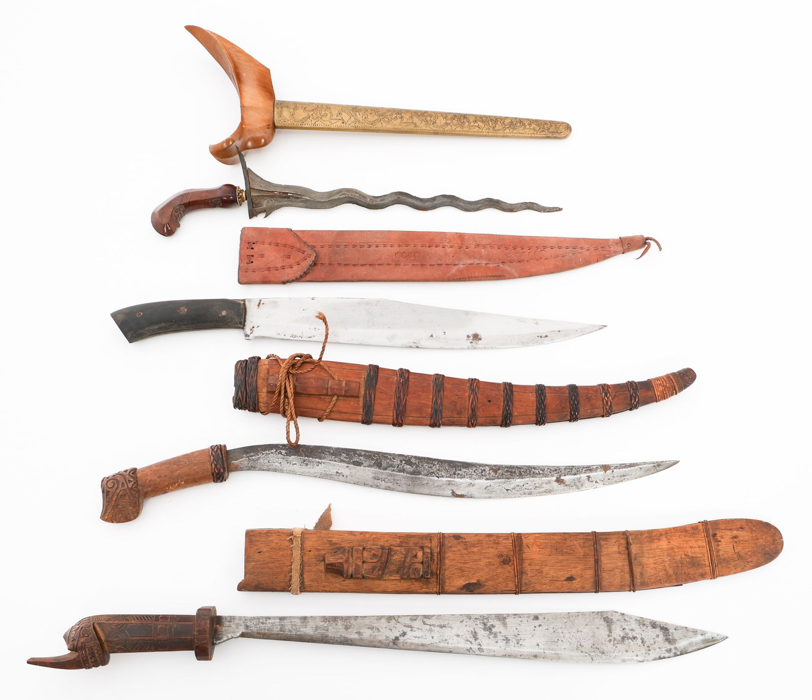 SOUTHEAST ASIAN ITAK, KRIS & TALIBON KNIVES: SOUTHEAST ASIAN ITAK, KRIS & TALIBON KNIVES Southeast Asian Fighting Knives. (2) Itak Knives. Single edged, slightly curved blades. Wood handles. Leather and wood scabbards. (1) Kris Knife. Double edg