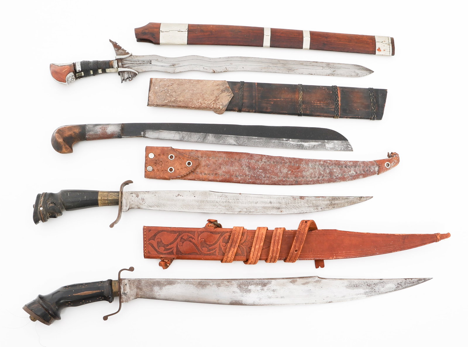 SOUTHEAST ASIAN ITAK, KRIS & PEDANG KNIVES: SOUTHEAST ASIAN ITAK, KRIS & PEDANG KNIVES Southeast Asian Fighting Knives. (2) Itak Knives. Wood and horn handles. Leather scabbards. (1) Kris Knife. Twine wrapped wood grip. Wood scabbard with metal
