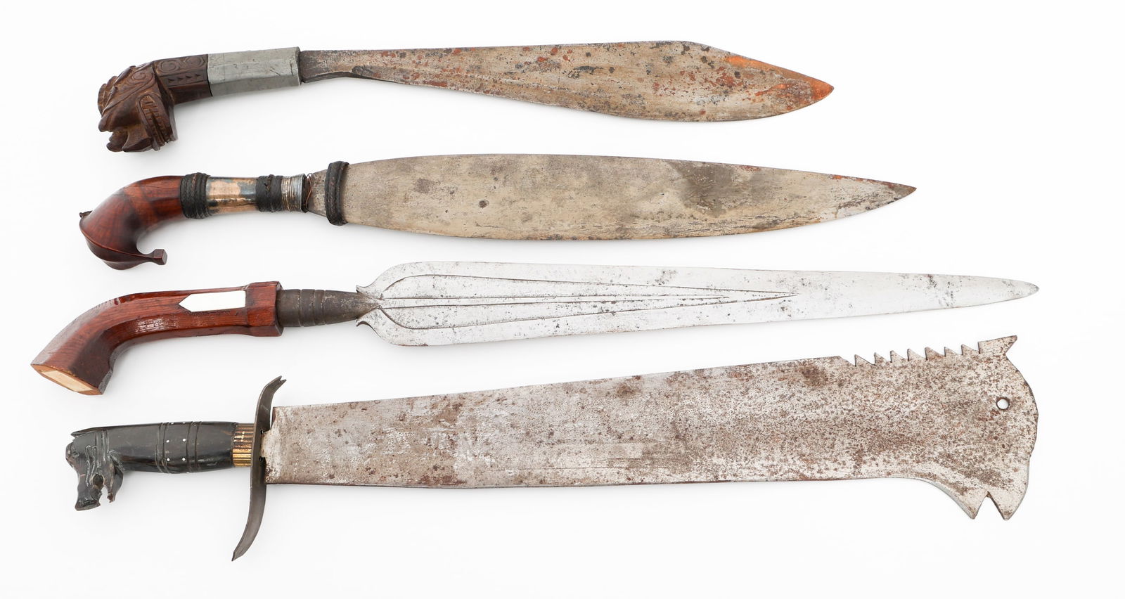 SOUTHEAST ASIAN FIGHTING KNIVES: SOUTHEAST ASIAN FIGHTING KNIVES Southeast Asian Fighting Knives. (1) Barong Knife. Brass and wood grip. No scabbard. (1) Itak Knife. Alloy and wood hilt. No scabbard. (1) Horse Head Machete. Horse hea