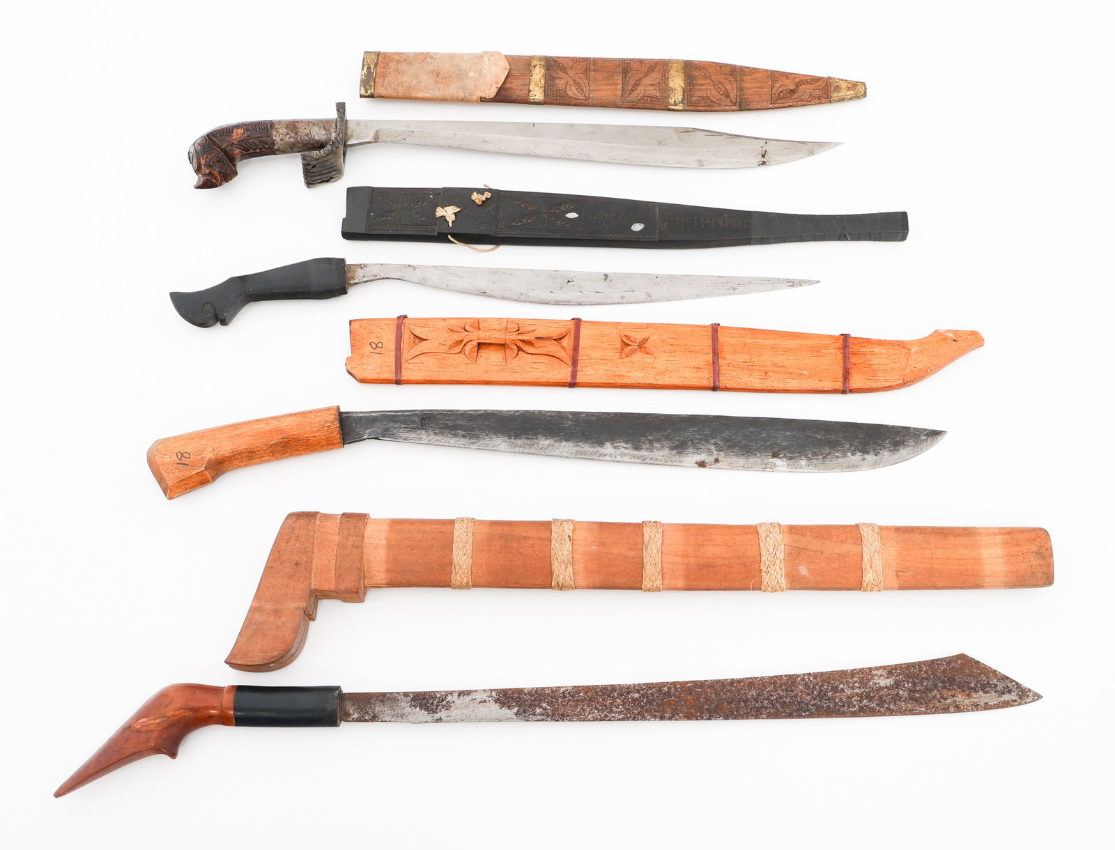 SOUTHEAST ASIAN GOLOK, PIRA & TALIBON KNIVES: SOUTHEAST ASIAN GOLOK, PIRA & TALIBON KNIVES Southeast Asian Fighting Knives. (1) Golok. Wooden handle and scabbard. (2) Pira. Wooden handle. Wooden scabbard with braided rattan wrap and brass fitting
