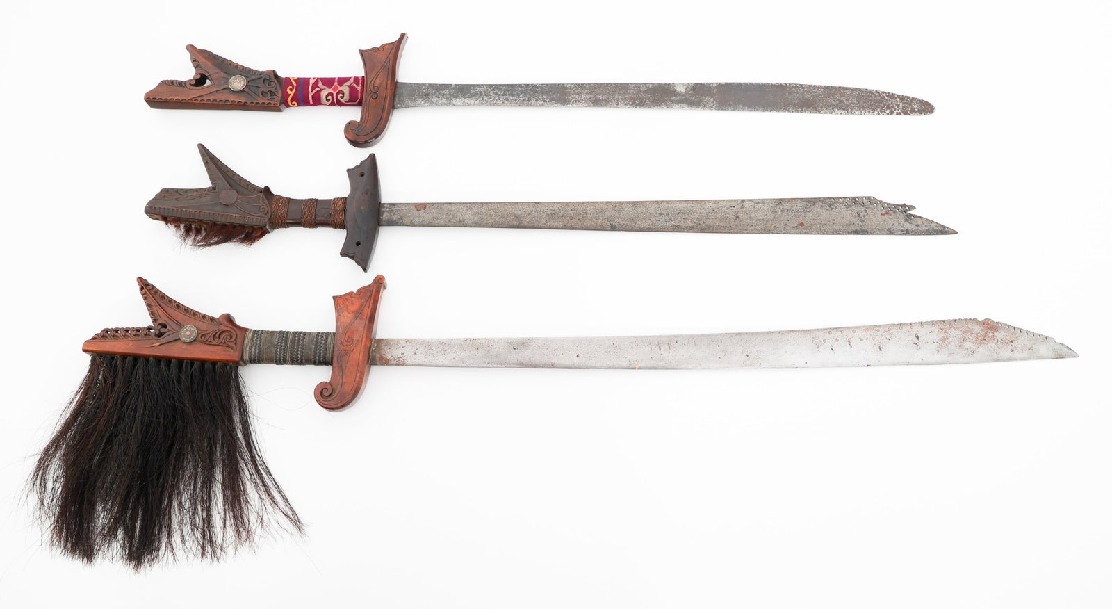 SOUTHEAST ASIAN KAMPILAN SWORDS: SOUTHEAST ASIAN KAMPILAN SWORDS Southeast Asian Kampilan Swords. (1) Kampilan. Wood handle with horse hair. (2) Kampilan. Wood handles. No scabbards. Blade Length: 27 1/8" to 32" Total Length: 37 1/2"