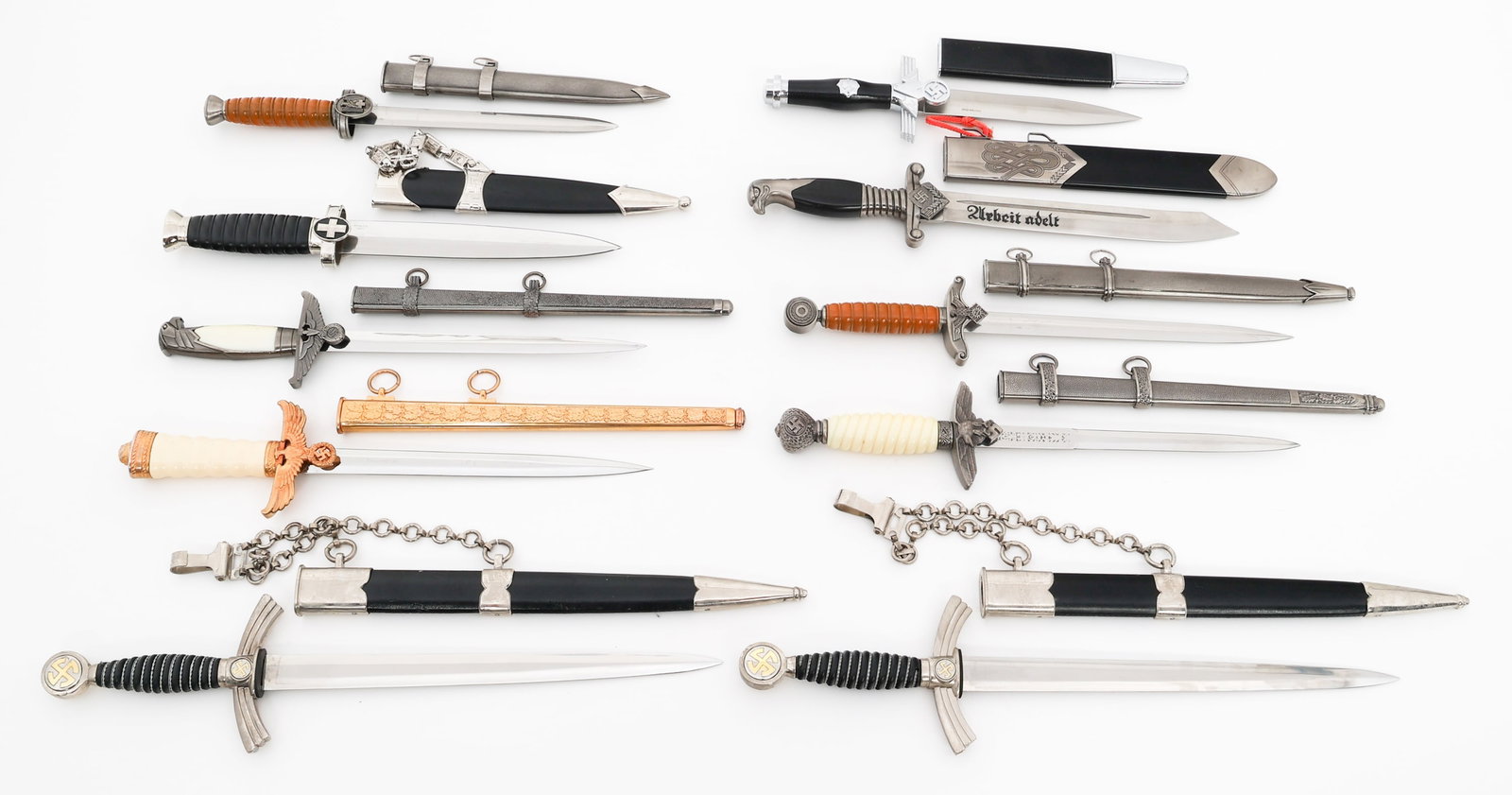 MODERN COPIES OF WWII GERMAN DRESS DAGGERS: MODERN COPIES OF WWII GERMAN DRESS DAGGERS Modern Copies of WWII German Dress Daggers. All have scabbards. Blade Length: 7 1/4" to 12" Total Length: 12" to 17 1/2" Provenance: Lifetime Edged Weapon & 