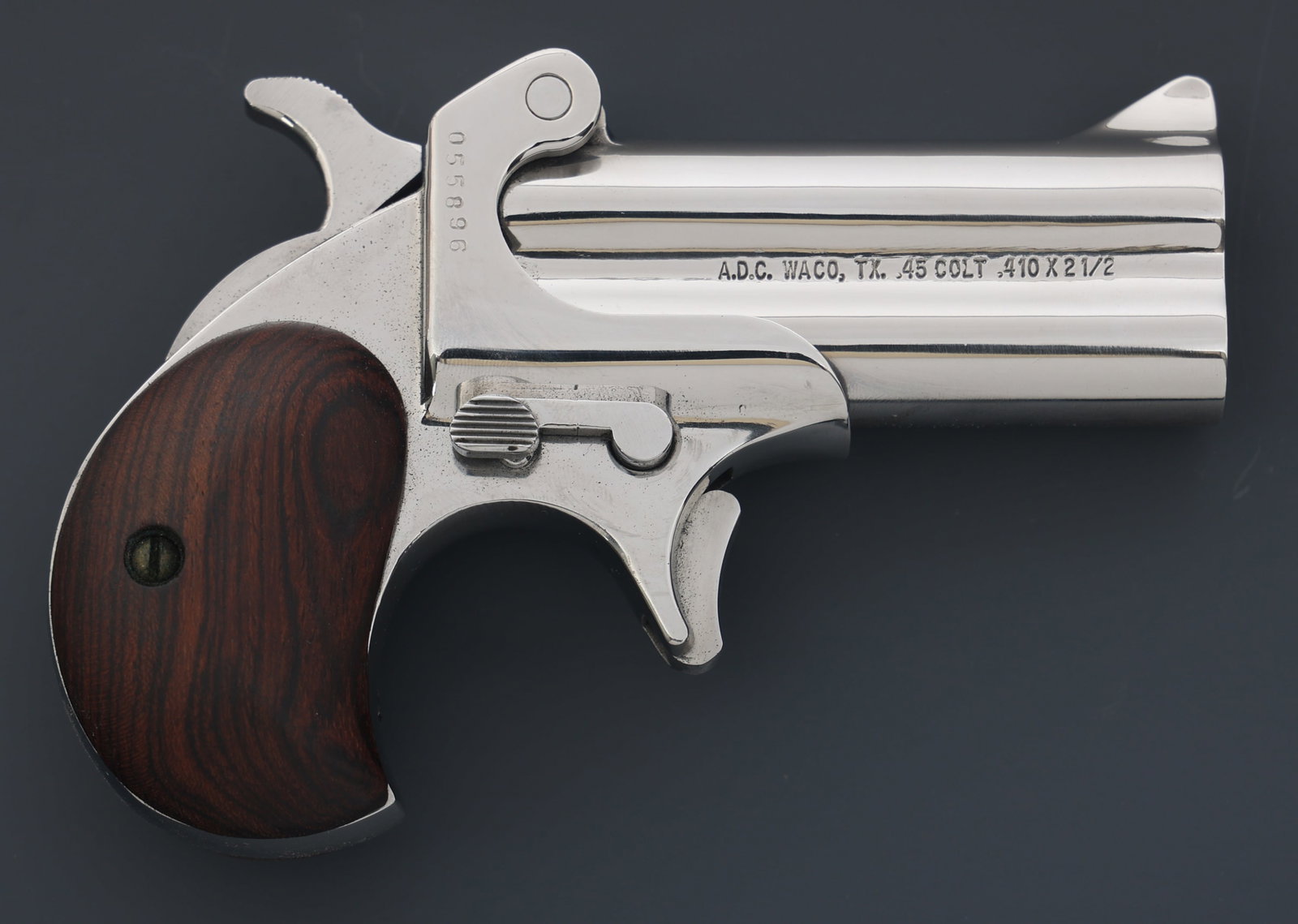 AMERICAN DERRINGER MODEL M-1 .45 COLT PISTOL: AMERICAN DERRINGER MODEL M-1 .45 COLT PISTOL American Derringer Corporation Model M-1 .45 Colt / .410 Gauge caliber derringer pistol. Wood grips. Fixed sights. Leather bag with literature. Caliber / G