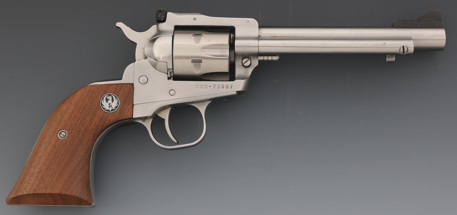 RUGER NEW MODEL SINGLE-SIX .22 LR CALIBER REVOLVER: RUGER NEW MODEL SINGLE-SIX .22 LR CALIBER REVOLVER Ruger New Model Single-Six .22 LR caliber SA revolver. Blade front sight. Adjustable rear sight. Six-shot fluted cylinder. Wood grips with Ruger meda