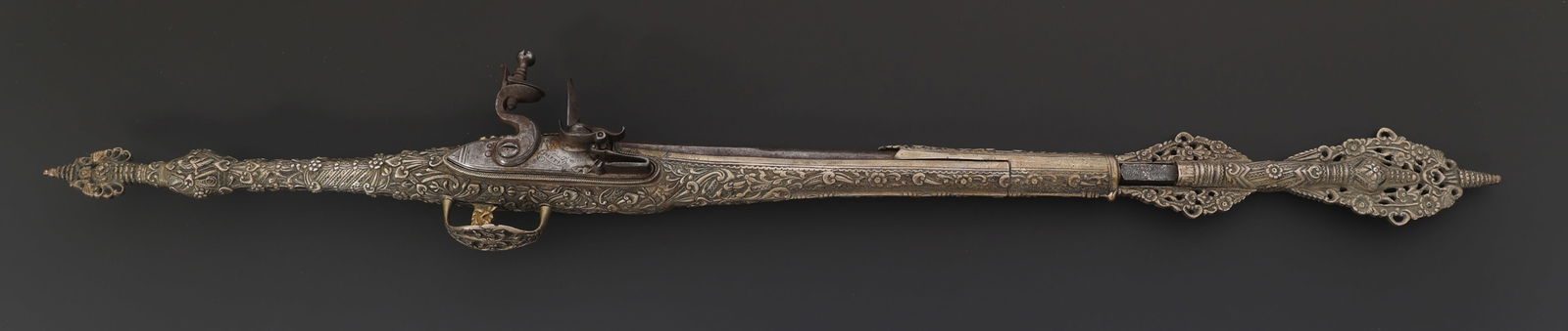 DECORATED .64 CALIBER FLINTLOCK PISTOL: DECORATED .64 CALIBER FLINTLOCK PISTOL Ornately decorated .64 caliber flintlock pistol. Relief engraving brass frame. Barrel top engraved SOFIANTINO with Lion proof marks in gold. Side plate engraved