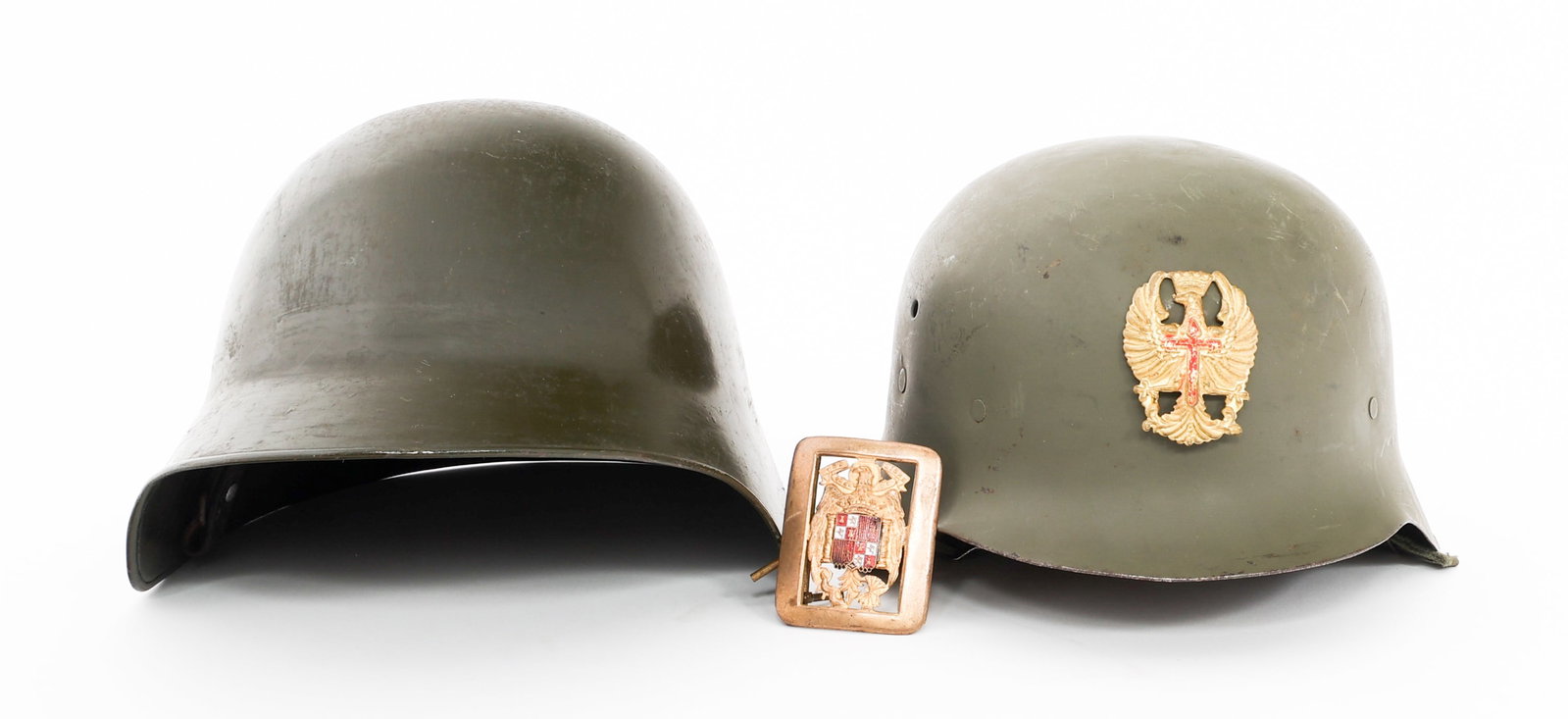 WWII - COLD WAR ARGENTINIAN & SPANISH HELMETS: WWII - COLD WAR ARGENTINIAN & SPANISH HELMETS WWII - Cold War Argentinian and Spanish Helmets and Belt Buckle. (1) Argentinian M38. Refinished shell with Argentinian cockade on the side. (1) Spanish M
