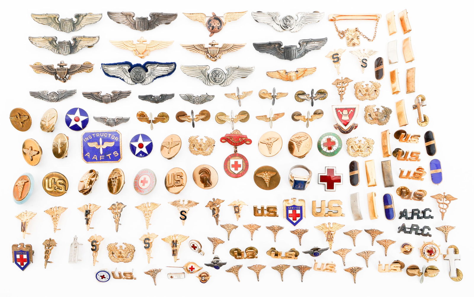 WWII - COLD WAR US & EUROPEAN MILITARY INSIGNIA: WWII - COLD WAR US & EUROPEAN MILITARY INSIGNIA WWII - Cold War US & European Military Insignia. Includes US Pilot Wings, British Red Cross Pin, US Collar Discs, DUI Pins, USN Ring, Tie Clip and more.