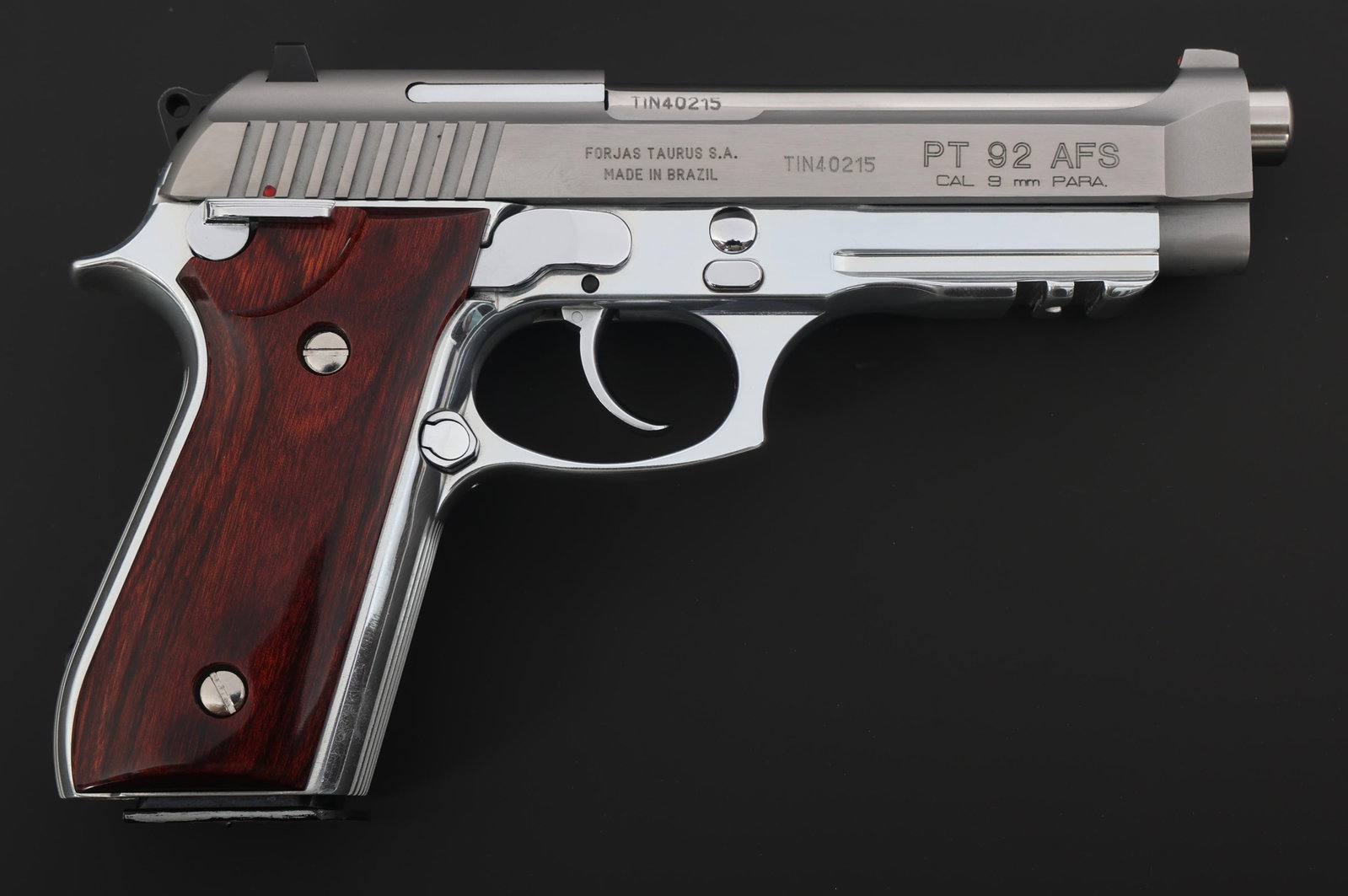 TAURUS MODEL PT 92AFS 9x19mm CALIBER PISTOL: TAURUS MODEL PT 92AFS 9x19mm CALIBER PISTOL Taurus Model PT 92AFS 9x19mm caliber semi automatic pistol. Stainless finish. Three dot sights. Wood grips. Two magazines. Original cardboard box. Caliber /