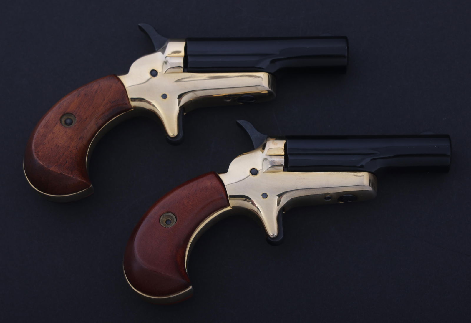 COLT MODEL LORD .22 SHORT DERRINGER PAIR: COLT MODEL LORD .22 SHORT DERRINGER PAIR Colt Model Lord .22 Short caliber derringer sequential pair. Top of barrels stamped -Colt-. Wood grips. Fixed sights. Caliber / Gauge: 22 S Barrel Length: 2.25