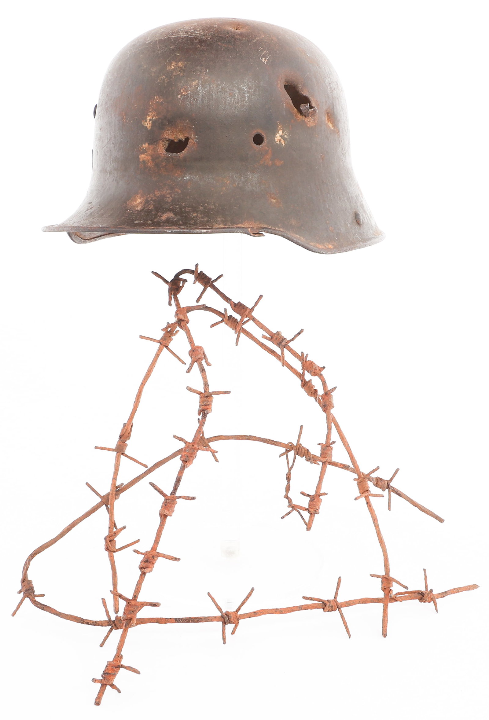 WWI GERMAN M16 HELMET & VERDUN BARBED WIRE: WWI GERMAN M16 HELMET & VERDUN BARBED WIRE WWI Imperial German M16 Stahlhelm Helmet and Verdun Barbed Wire. (1) M16. "B.F. 64" stamped near the brim. No liner. (3) Section of barbed wire. Provenance t