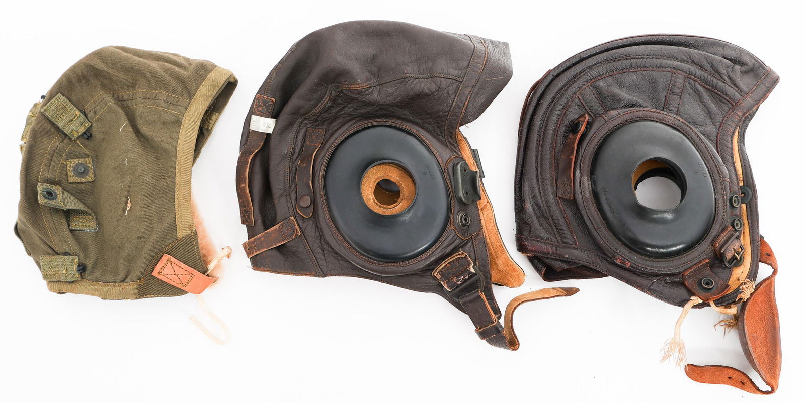 WWII USAAF TYPE A-9 & A-11 & USN FLYING HELMETS: WWII USAAF TYPE A-9 & A-11 & USN FLYING HELMETS WWII USAAF and US Navy Flying Helmets. (1) Type A-9. OD green cotton construction. Fleece ear cups and chinstrap pad. Army Air Forces contract tag prese