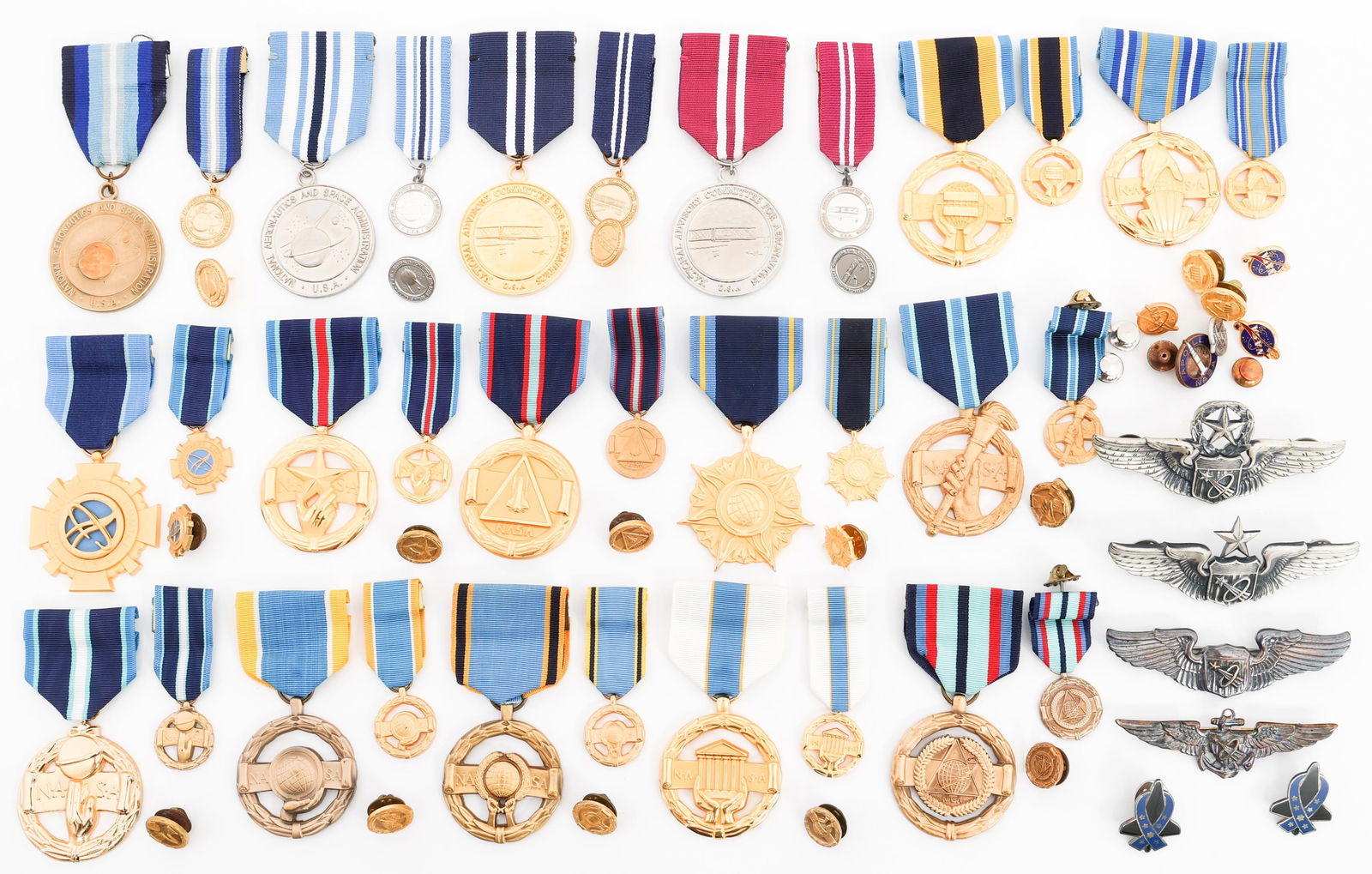 COLD WAR - CURRENT NASA MEDALS, PINS & WINGS: COLD WAR - CURRENT NASA MEDALS, PINS & WINGS Cold War Era - Current NASA Full size and Mini Medals, Pins and Wings. (1) USAF Command Astronaut Pilot 3" Wings. Marked Sterling. (1) USAF Senior Astronau