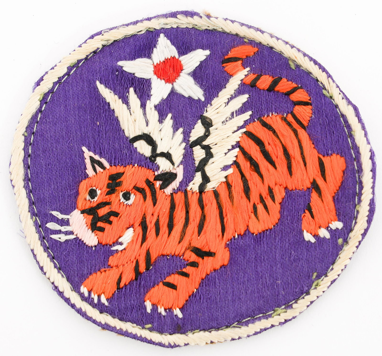 WWII USAAF CBI FLYING TIGERS THEATER MADE PATCH: WWII USAAF CBI FLYING TIGERS THEATER MADE PATCH WWII USAAF CBI 14th Air Force "Flying Tigers" Theater Made Patch. Hand stitched silk embroidery with cloth backing. Size: 2 3/4" Provenance: Lifetime Mi