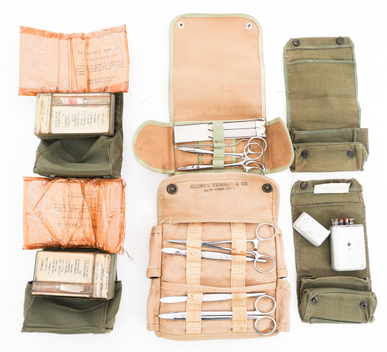 WWII USN SURGICAL INSTRUMENTS & FIRST AID KITS: WWII USN SURGICAL INSTRUMENTS & FIRST AID KITS WWII US Navy Surgical Instruments and Aviator First Aid Kits. (1) USN MD Pocket Case by George Tiemann & Co. Includes surgical instruments. (1) Surgical 