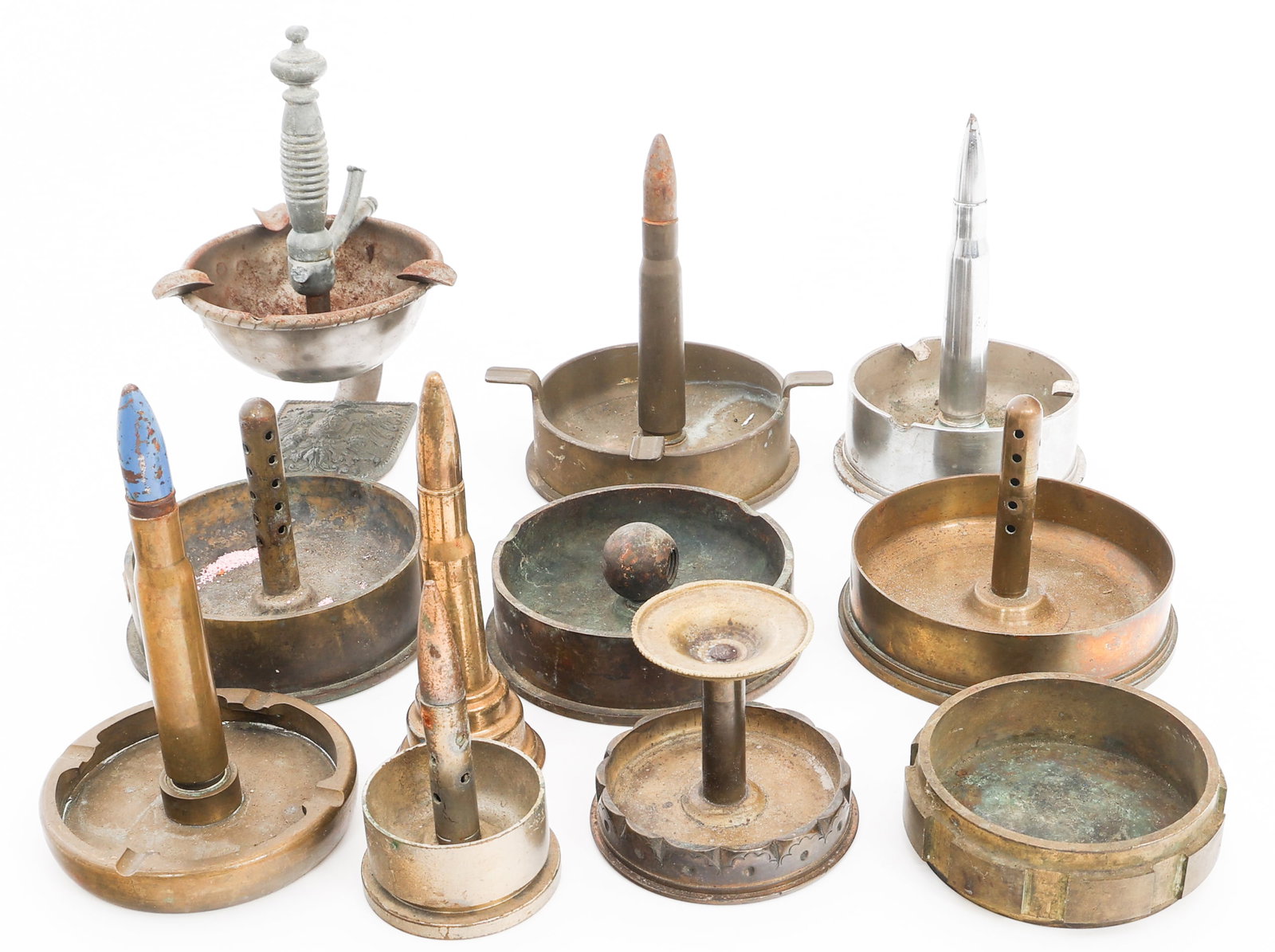 WWII US ARMY ORDNANCE TRENCH ART ASH TRAYS: WWII US ARMY ORDNANCE TRENCH ART ASH TRAYS WWII US Army Ordnance Trench Art Ash Trays. Includes various calibers. Size: 3" to 7 1/2" Weight: 20 lbs. Provenance: Lifetime Military Memorabilia & Arms Co