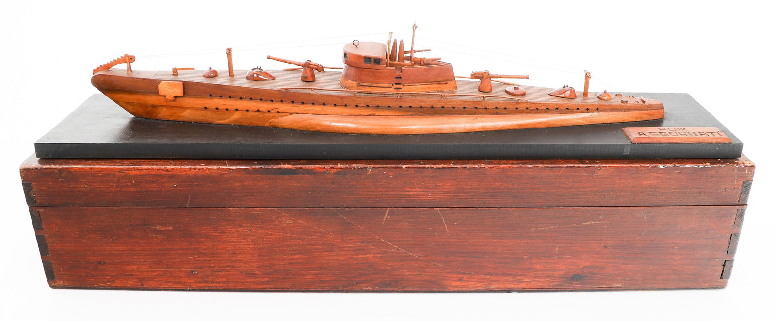 WWII GERMAN WOODEN U-BOAT MODEL DESK DISPLAY: WWII GERMAN WOODEN U-BOAT MODEL DESK DISPLAY WWII German Wooden U-Boat Model Desk Display. Wooden plaque hand carved "POW A. Sgorbati" present in the bottom right corner. Size: 26" x 7" x 5" Provenanc