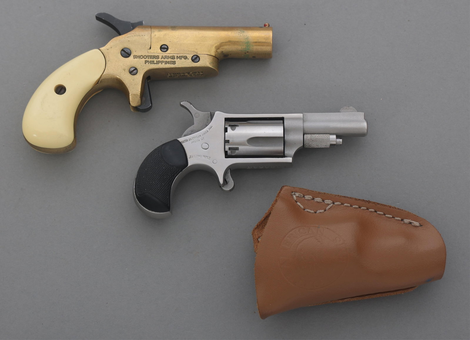 NAA NAA-22LR REVOLVER & SHOOTER ARMS DERRINGER: NAA NAA-22LR REVOLVER & SHOOTER ARMS DERRINGER North American Arms revolver and Shooters Arms Derringers. A) North American Arms .22 LR revolver pistol. Stainless steel. Checkered rubber grips. Five s