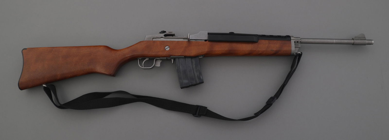 RUGER MODEL MINI-14 .223 CALIBER RANCH RIFLE: RUGER MODEL MINI-14 .223 CALIBER RANCH RIFLE 1990 Ruger mini 14 .223 Rem. caliber semi automatic Ranch rifle. Stainless steel. Wood stock. Metal butt plate. Blade front sight. Adjustable rear sight. S