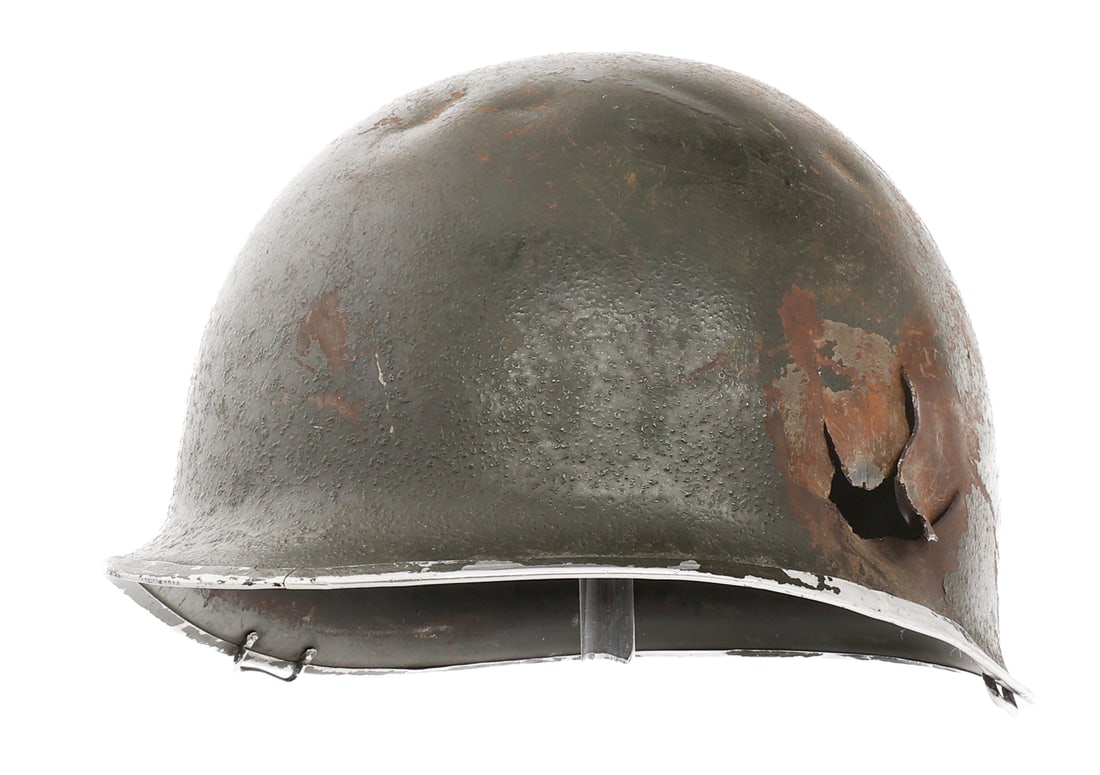 WWII US ARMY M1 COMBAT HELMET SHELL: WWII US ARMY M1 COMBAT HELMET SHELL WWII US Army M1 Combat Helmet Shell. Front seam, fixed bale, late 1943 McCord production. Lot number "667A' heat stamped near the brim. Helmet has been shot through