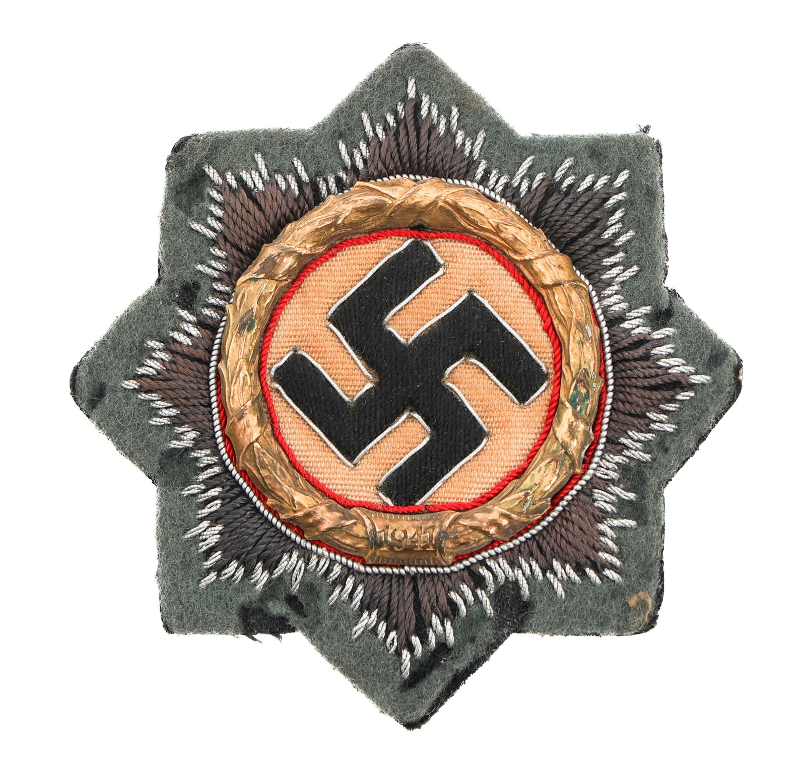 WWII GERMAN CROSS IN GOLD CLOTH BULLION EMBROIDERY: WWII GERMAN CROSS IN GOLD CLOTH BULLION EMBROIDERY WWII German Cross in Gold. Cloth version in cotton and silver thread embroidery. Paper backing maker marked by Hermann Schmuck & Cie. Size: 68.1 mm