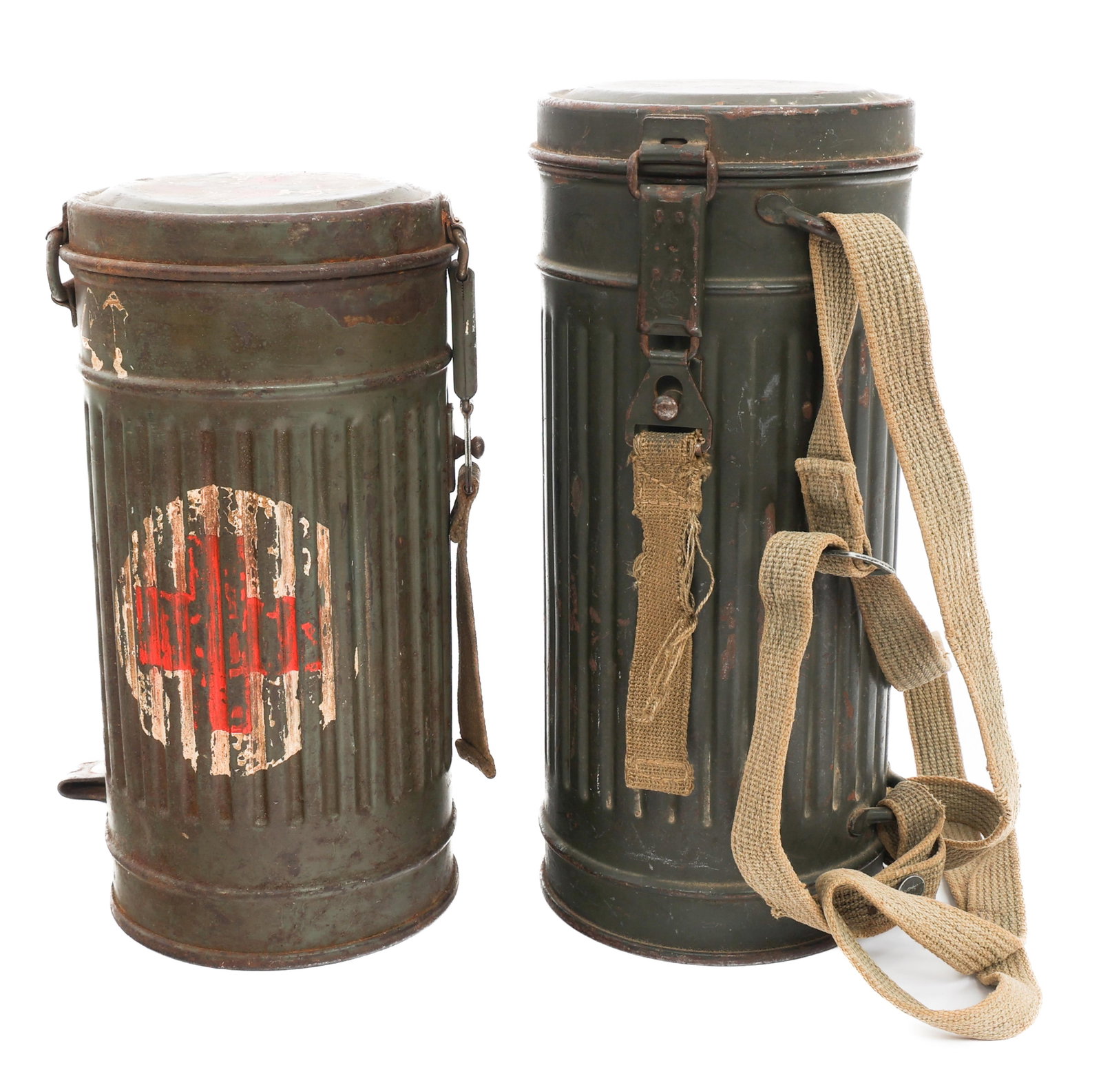 WWII GERMAN GAS MASK CANISTERS: WWII GERMAN GAS MASK CANISTERS WWII German Gas Mask Canisters. One includes carrying strap. One with Red Cross emblem present on the side. Provenance: Estate Militaria & Arms Collection of Dr. Steven 