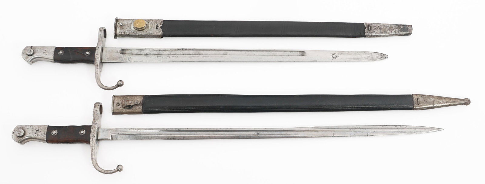 WWI OTTOMAN M1903 MAUSER BAYONETS: WWI OTTOMAN M1903 MAUSER BAYONETS WWI Ottoman M1903 Mauser Bayonets. Single edged blades with fuller, one is pipe back. Arabic and Ottoman proof marks on the ricassos and spines. Steel hilts with wood