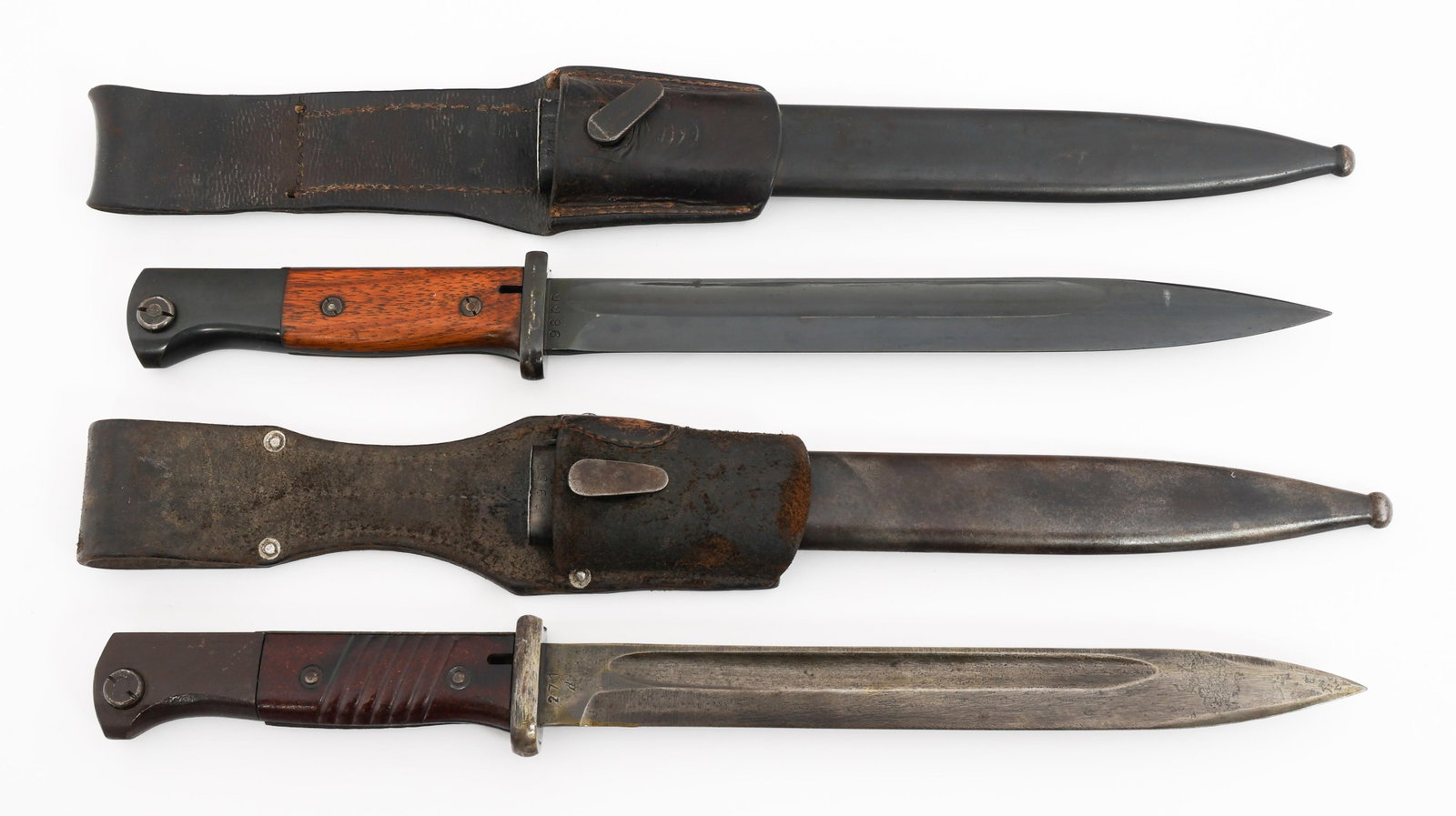 WWII GERMAN K98 COMBAT BAYONETS: WWII GERMAN K98 COMBAT BAYONETS WWII German K98 Combat Bayonets. (2) Combat K98. One maker marked by S/177K, one illegible. Serial numbered on the reverse. Steel hilt with wood and bakelite grips. Ste