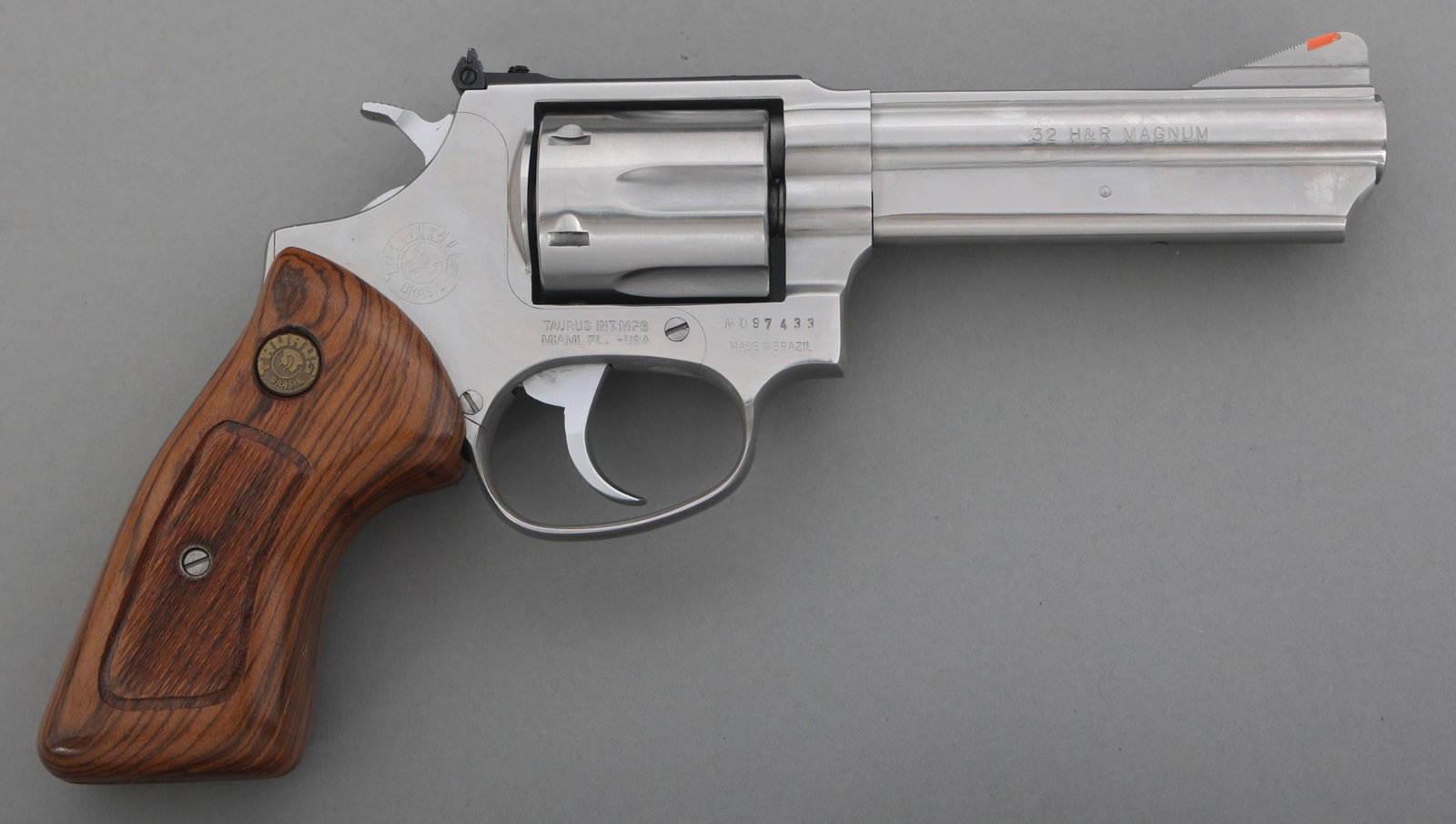 TAURUS MODEL 741 .32 H&R CALIBER DA REVOLVER: TAURUS MODEL 741 .32 H&R CALIBER DA REVOLVER Taurus Model 741 32 H&R magnum caliber double action revolver. Stainless steel. Checkered wood grips with Taurus medallion. Ramp front sight with red inser