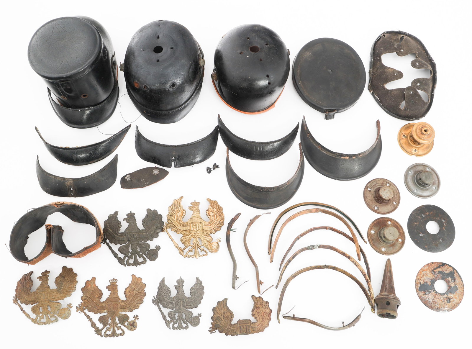 IMPERIAL GERMAN PICKELHAUBE & SHAKO ASSORTED PARTS: IMPERIAL GERMAN PICKELHAUBE & SHAKO ASSORTED PARTS Imperial German Pickelhaube and Shako Assorted Parts and Accoutrements. Includes Pickelhaube and Shako leather shell, brass tops, rims, badges and ot
