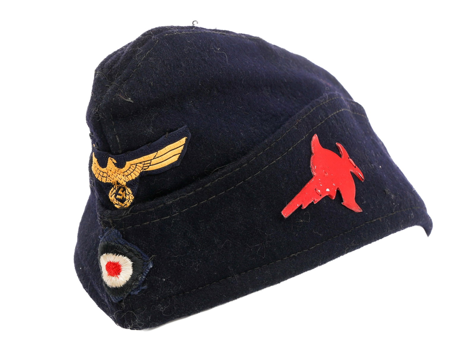 WWII GERMAN U-BOAT 9th FLOTILLA OVERSEAS CAP: WWII GERMAN U-BOAT 9th FLOTILLA OVERSEAS CAP WWII German U-Boat 9th Flotilla Enlisted/NCO Overseas Cap. Dark blue wool construction with alloy 9th Flotilla swordfish badge on one side. Bevo Kriegsmari