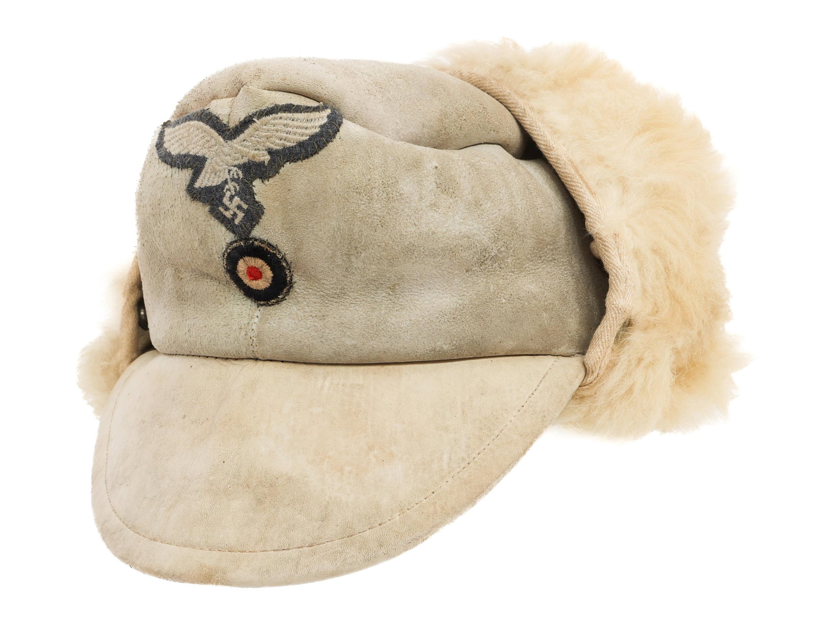 WWII GERMAN LUFTWAFFE WINTER FUR CAP: WWII GERMAN LUFTWAFFE WINTER FUR CAP WWII German Luftwaffe Winter Fur Cap. Fur and leather construction with ear flaps and visor. Embroidered Luftwaffe eagle and cockade cap badges. Maker marked by Be