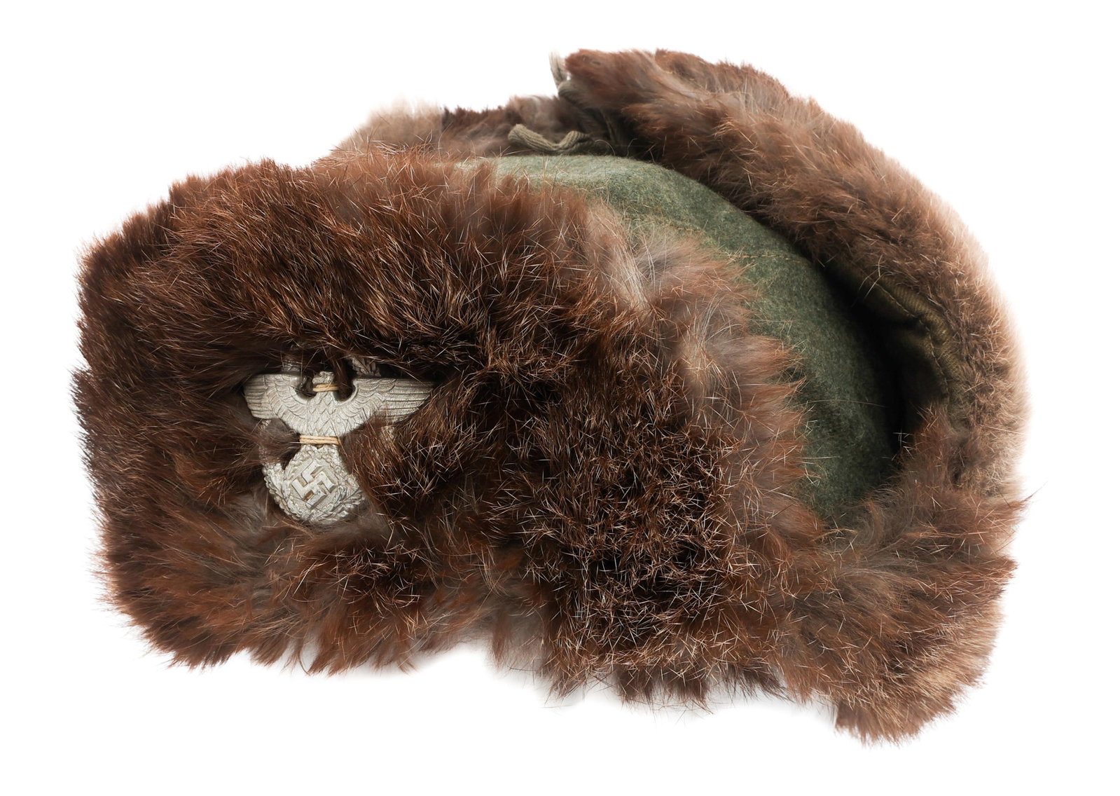 WWII GERMAN POLICE WINTER FUR CAP: WWII GERMAN POLICE WINTER FUR CAP WWII German Police Winter Fur Cap. Feldgrau wool and animal fur construction with ear flaps. Police eagle cap badge. Maker mark is present, but faded. Dated 1942. Siz