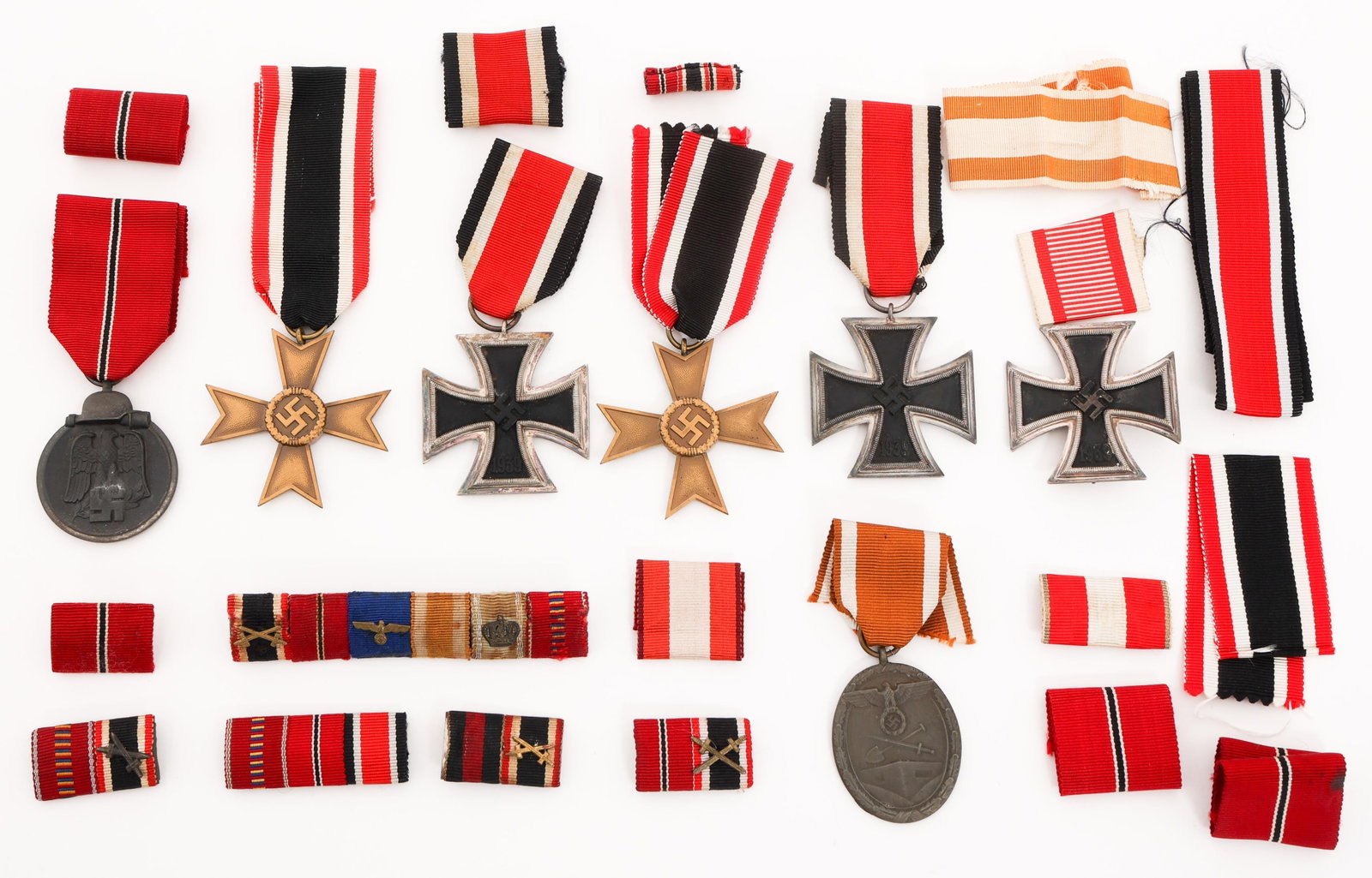 WWII GERMAN IRON, WAR MERIT CROSSES & MEDALS: WWII GERMAN IRON, WAR MERIT CROSSES & MEDALS WWII German Iron Crosses and Medals. (1) Iron Cross 1st Class. (2) Iron Cross 2nd Class. 25 stamped on one of the rings. (1) West Wall Medal. (1) Winter in