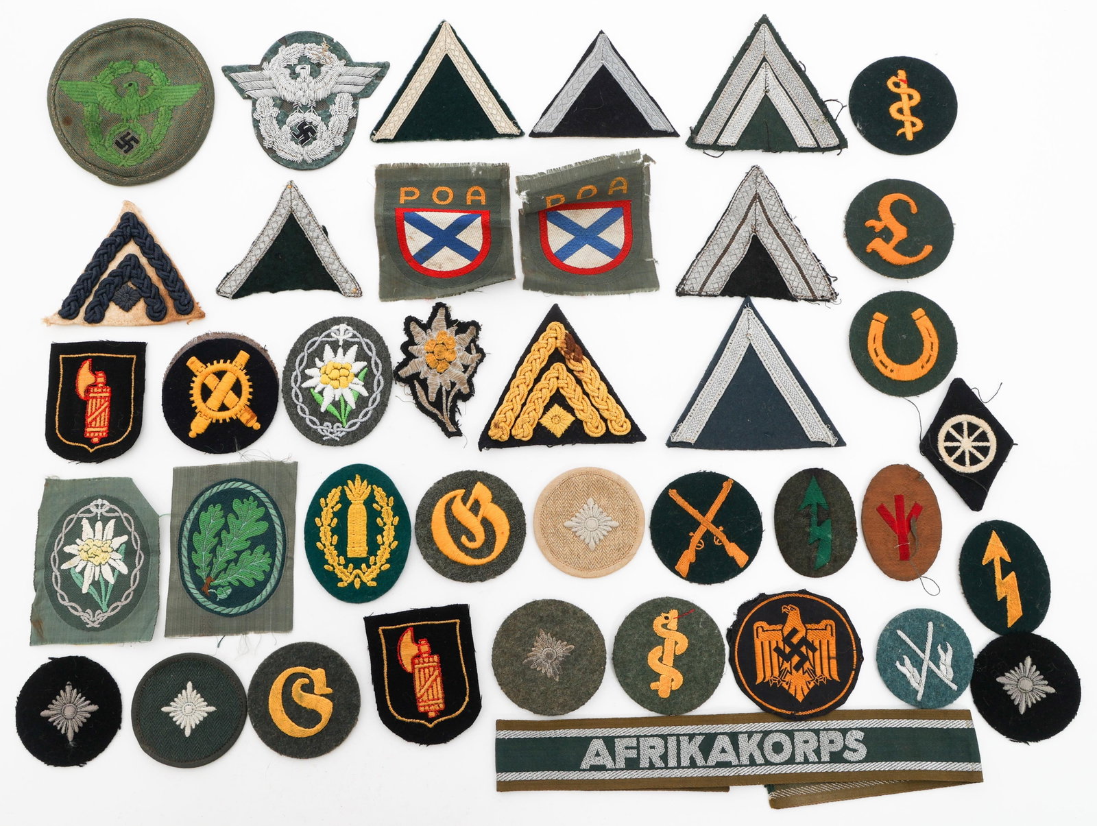 WWII GERMAN HEER, POLICE RANK & TRADE INSIGNIA: WWII GERMAN HEER, POLICE RANK & TRADE INSIGNIA WWII German Heer, Police an POA Insignia. Includes rank chevrons and pips, trade patches, POA volunteer patches, Italian Grenadier Volunteer patches, DAK