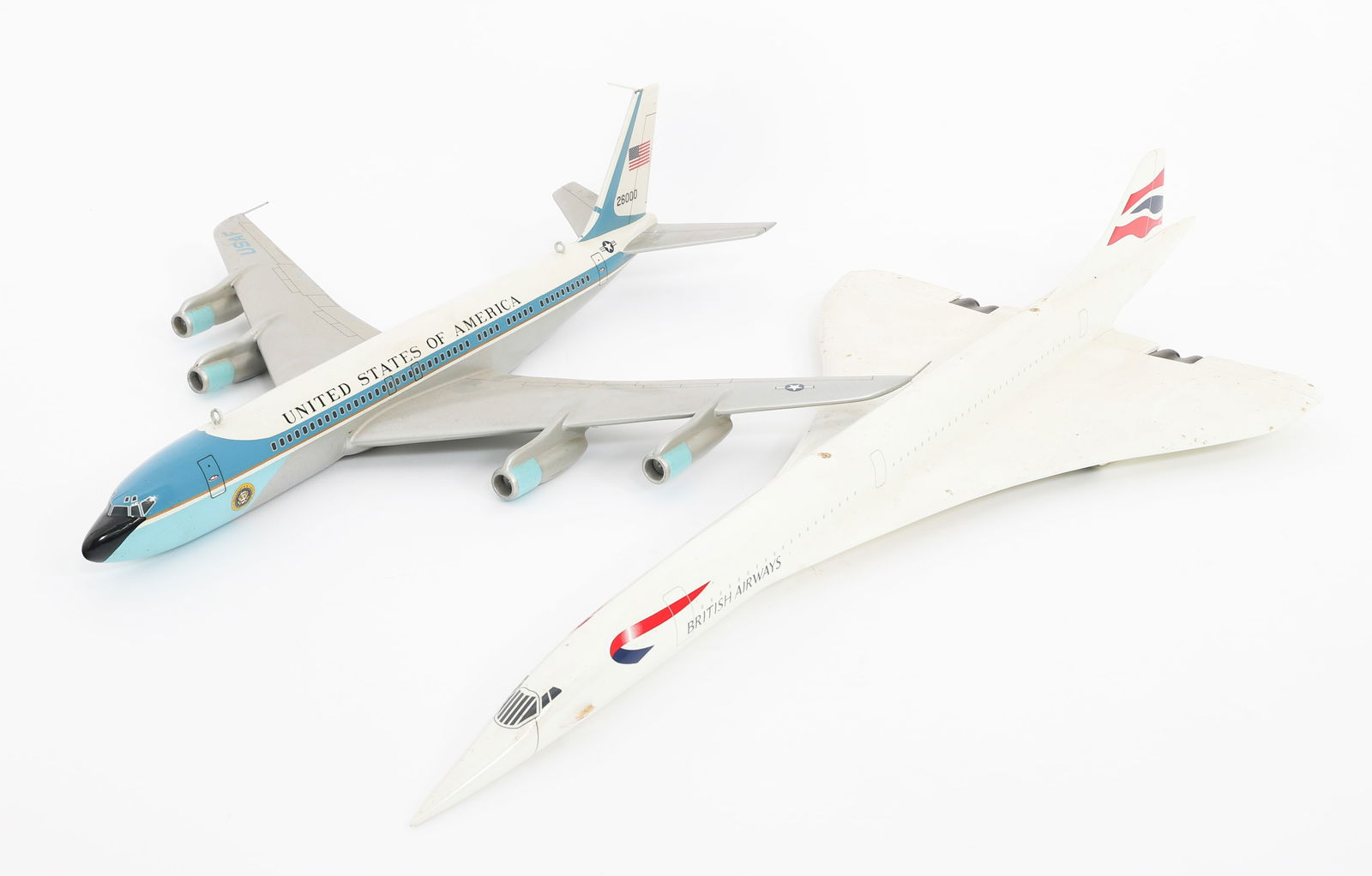 BRITISH AIRWAYS CONCORDE & AIR FORCE ONE MODELS: BRITISH AIRWAYS CONCORDE & AIR FORCE ONE MODELS British Airways Concorde and Air Force One Model Airplanes. Painted mahogany. No stands. No visible maker marks. Size: 18" to 25" x 11" to 18" x 4" x 5"