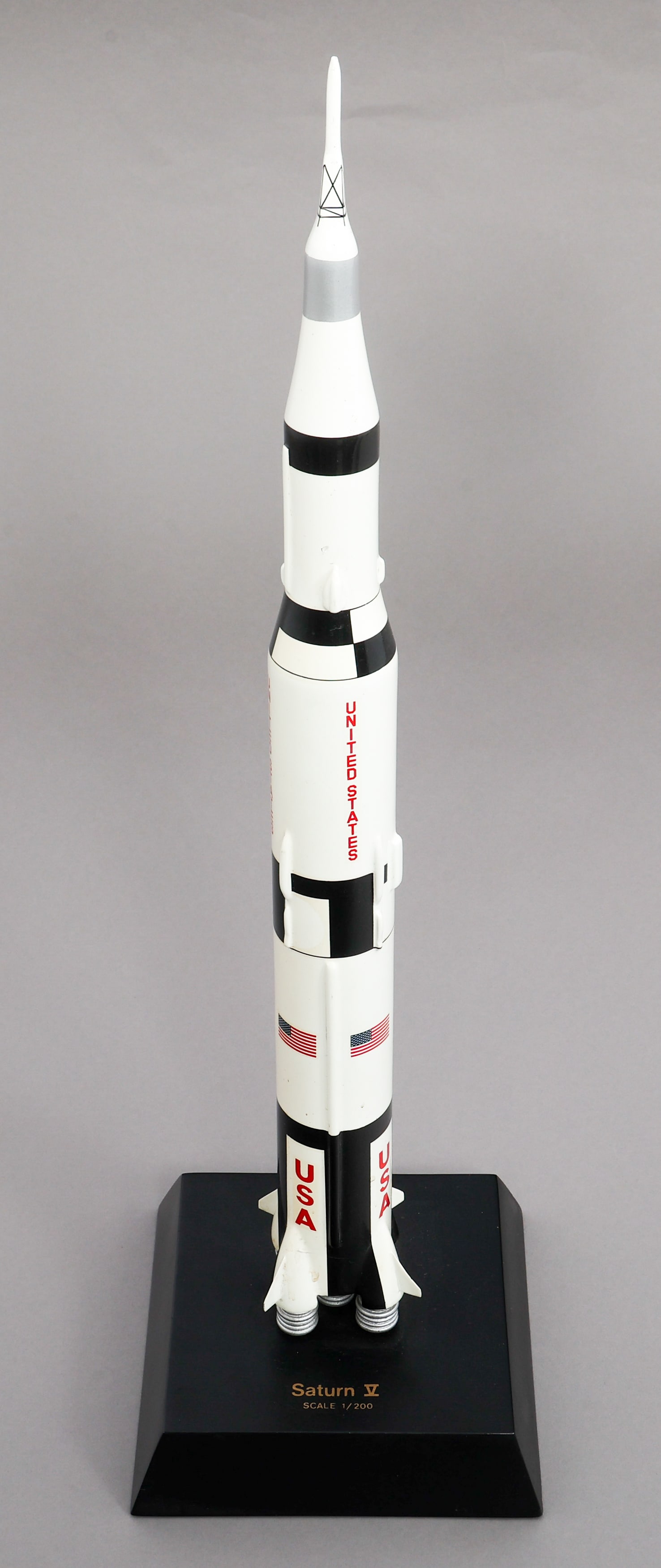 SATURN V 1/200 SCALE MODEL SPACE ROCKET: SATURN V 1/200 SCALE MODEL SPACE ROCKET Saturn V 1/200 Scale Model Space Rocket. Painted mahogany construction. Maker marked by Toys and Model Corporation on the bottom. Size: 7" x 7" x 23 1/2"
