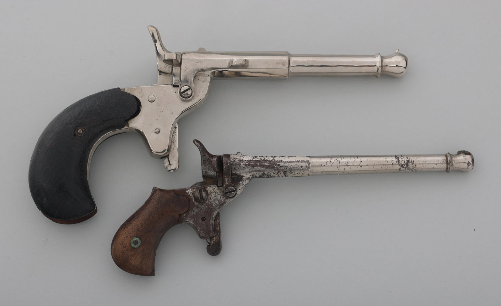GERMAN 6mm FLOBERT CALIBER PARLOR PISTOLS: GERMAN 6mm FLOBERT CALIBER PARLOR PISTOLS Two German 6mm caliber Flobert single shot parlor pistols. A) German 6mm Flobert single shot parlor pistol. "31" stamped on ejector lever. Nickel plated. Wood