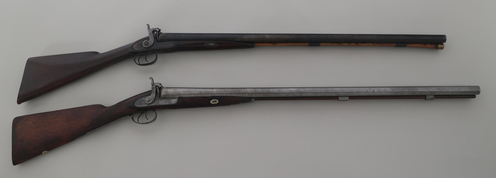 10 GAUGE PERCUSSION SHOTGUNS: 10 GAUGE PERCUSSION SHOTGUNS Two 10 gauge percussion shotguns. A) W. Richards 10 gauge side by side percussion shotgun. Barrel stamped "London Fine Twist". Wood stock. Bead front sight. Ram rod. B) C.