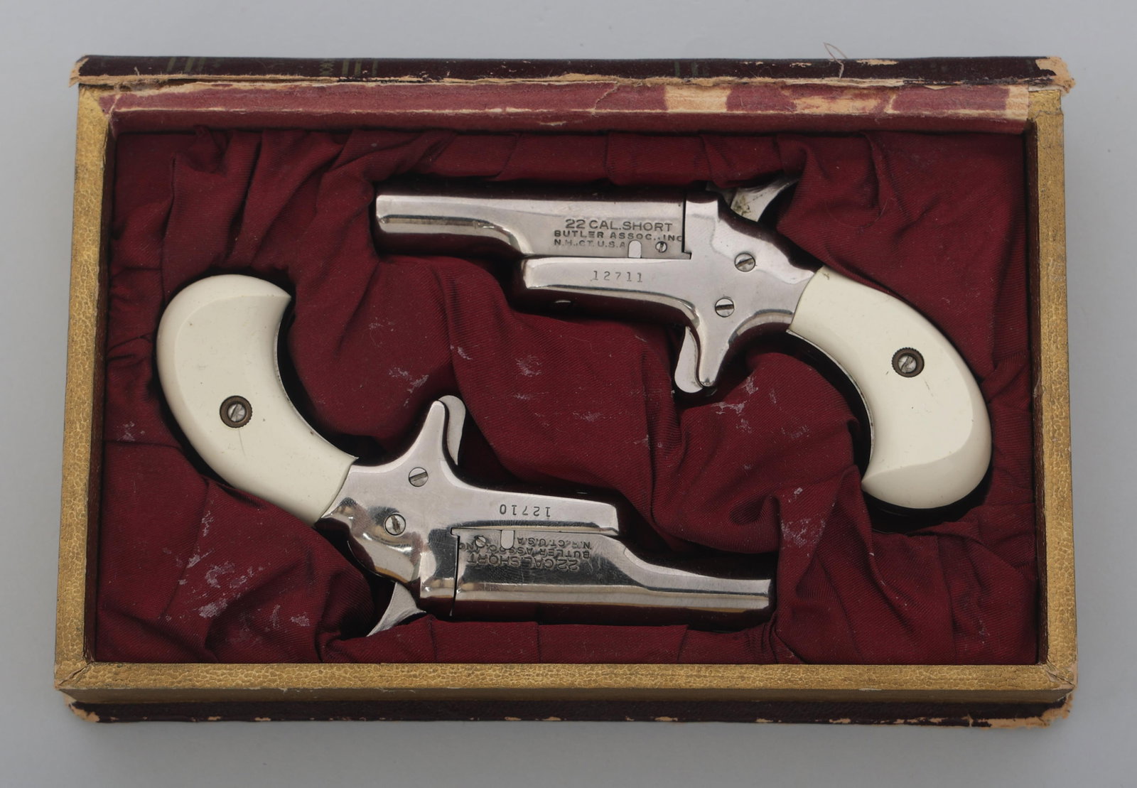 BUTLER DERRINGER .22 CAL SEQUENTIAL PISTOL SET: BUTLER DERRINGER .22 CAL SEQUENTIAL PISTOL SET Sequential pair of Butler .22 S caliber Derringer pistols in box. Nickel finish. Composite grips. Front blade sight. Rear sight on hammer. Left side of b