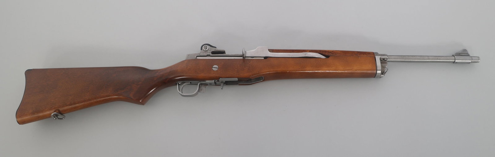 RUGER MODEL MINI-14 .223 CALIBER RANCH RIFLE: RUGER MODEL MINI-14 .223 CALIBER RANCH RIFLE Ruger mini 14 .223 Remington caliber semi automatic Ranch rifle. Stainless steel finish. Blade front sight. Adjustable rear peep sight. Wood stock and hand