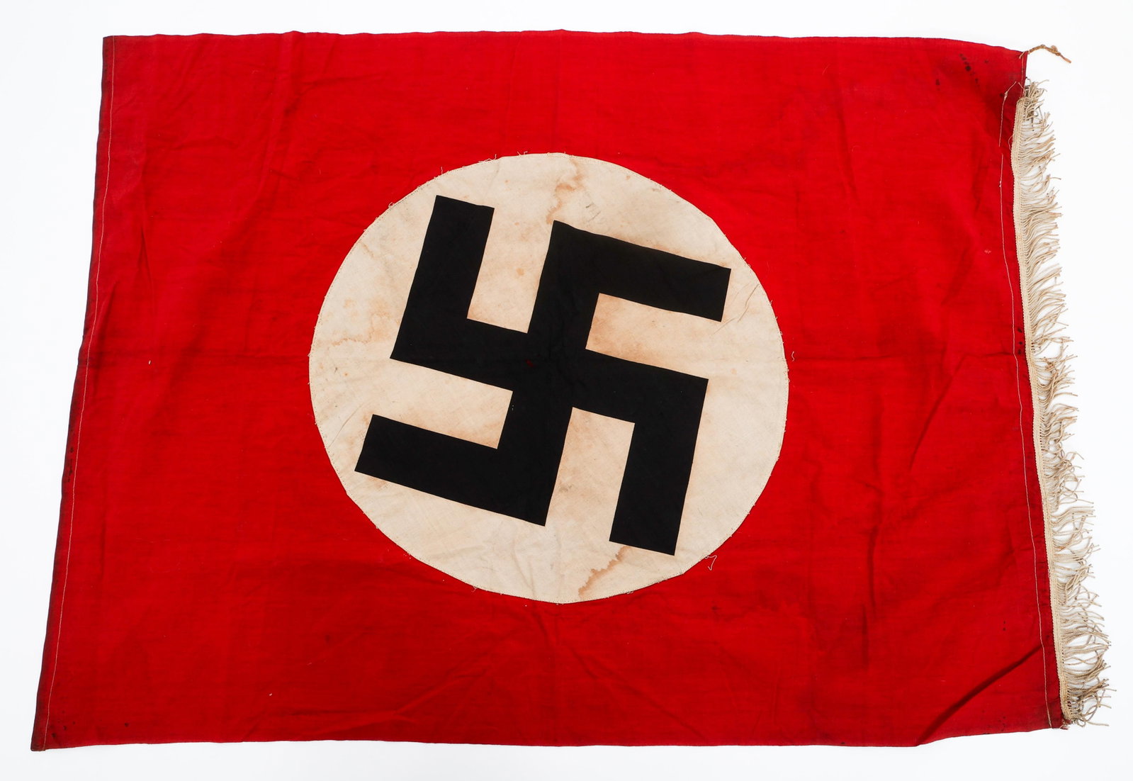 WWII GERMAN NSDAP PODIUM BANNER: WWII GERMAN NSDAP PODIUM BANNER WWII German NSDAP Podium Banner. Single sided, two-piece cotton construction with printed emblem. Single edge fringe border. No visible maker marks. Size: 40" x 30"