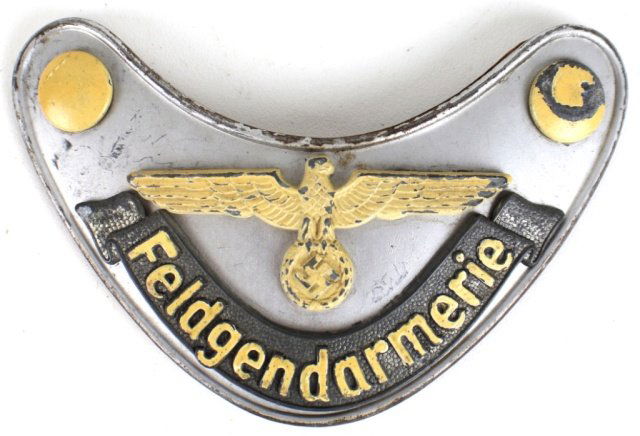 FELDGENDARMERIE GERMAN WWII MILITARY POLICE GORGET: FELDGENDARMERIE GERMAN WWII THIRD REICH MILITARY POLICE GORGET A German WWII military police (Feldgendarmerie) gorget, which was suspended by a chain around the officer's neck. Chain mounts are locate