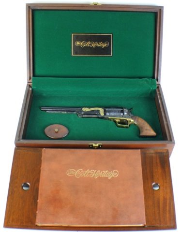 COLT HERITAGE COMMEMORATIVE BLACK POWDER .44 CAL: COLT HERITAGE COMMEMORATIVE BLACK POWDER .44 CAL Colt Heritage Commemorative black powder .44 Cal percussion cap revolver with Colt Heritage book and display case. Blued 9 inch barrel and chamber, ton