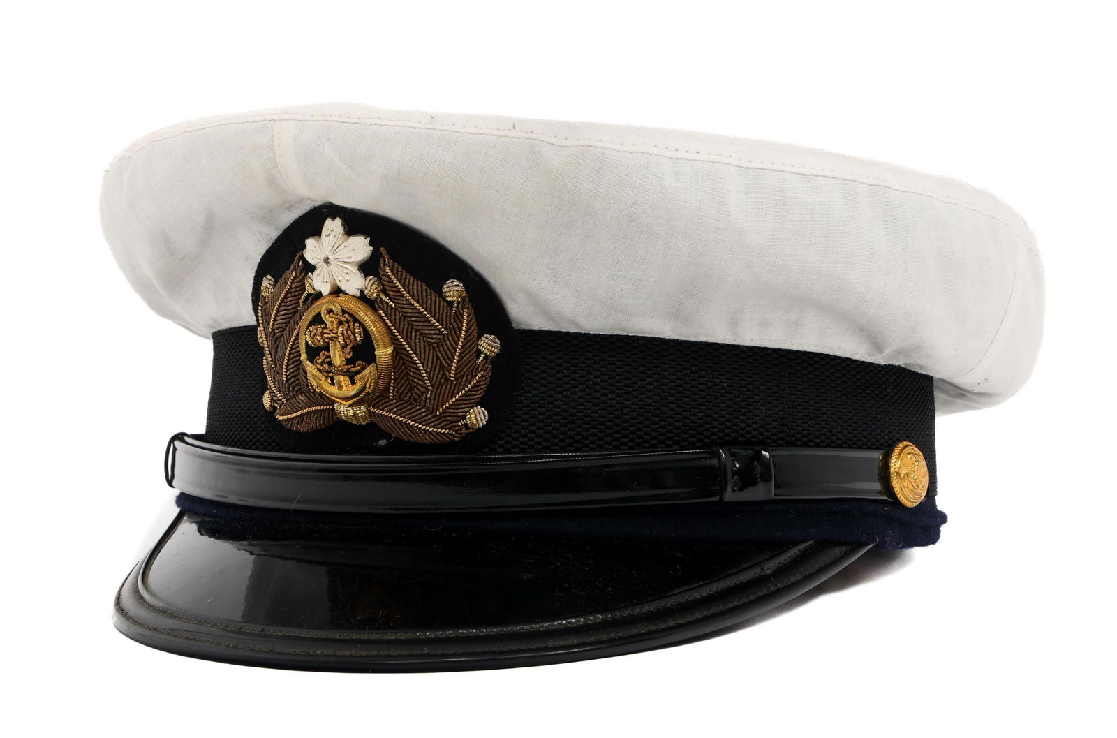 WWII IMPERIAL JAPANESE NAVY OFFICER VISOR CAP: WWII IMPERIAL JAPANESE NAVY OFFICER VISOR CAP WWII Imperial Japanese Navy Officer Visor Cap. Dark blue wool construction with white linen summer cover. Bullion officer cap badge. Black leather chinstr