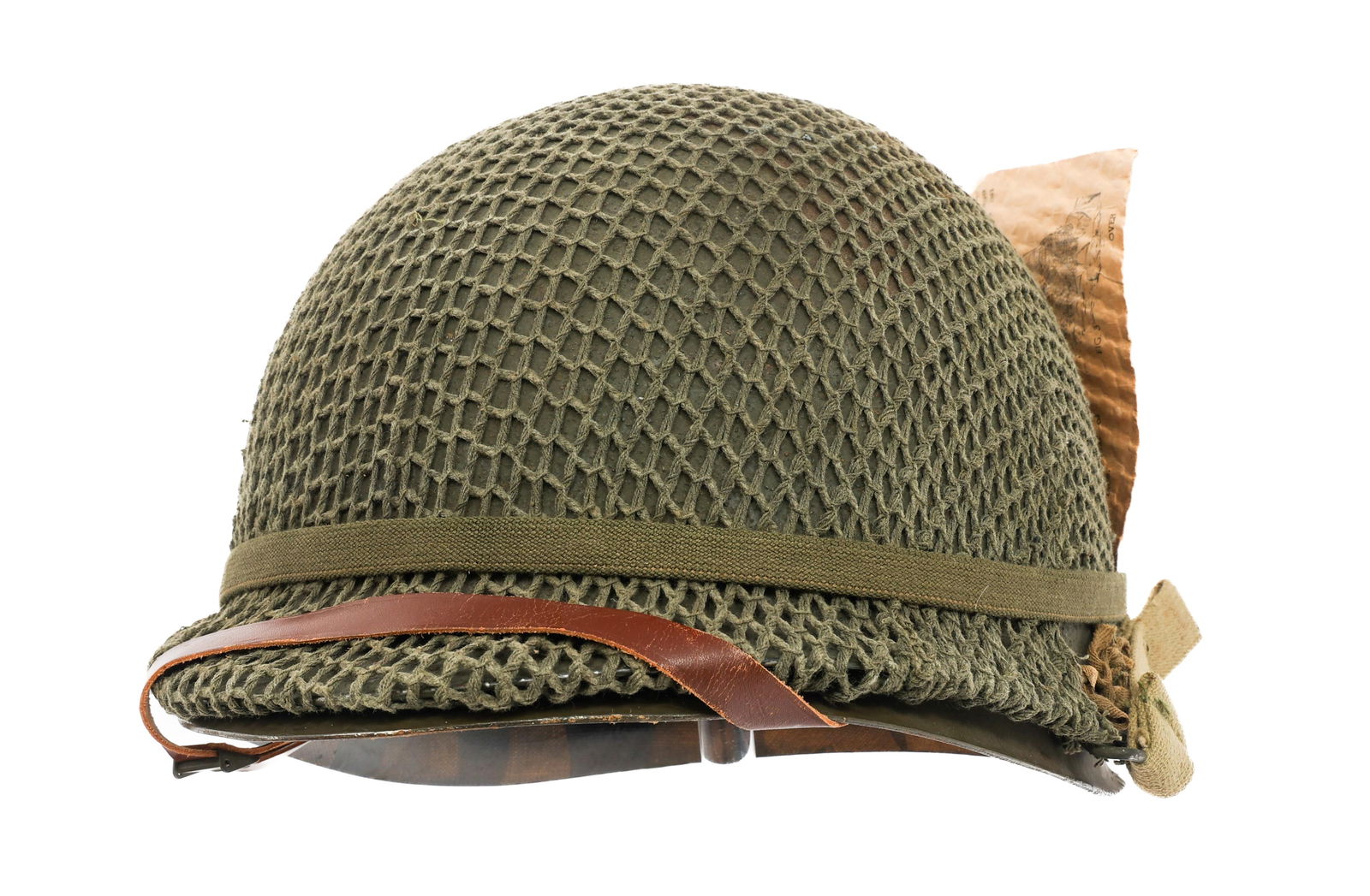 WWII US ARMY M1 COMBAT HELMET WITH CAMO NET: WWII US ARMY M1 COMBAT HELMET WITH CAMO NET WWII US Army M1 Combat Helmet. Front seam, swivel bale with OD3 chinstrap, camouflage netting, and elastic band with user's manual. McCord production shell