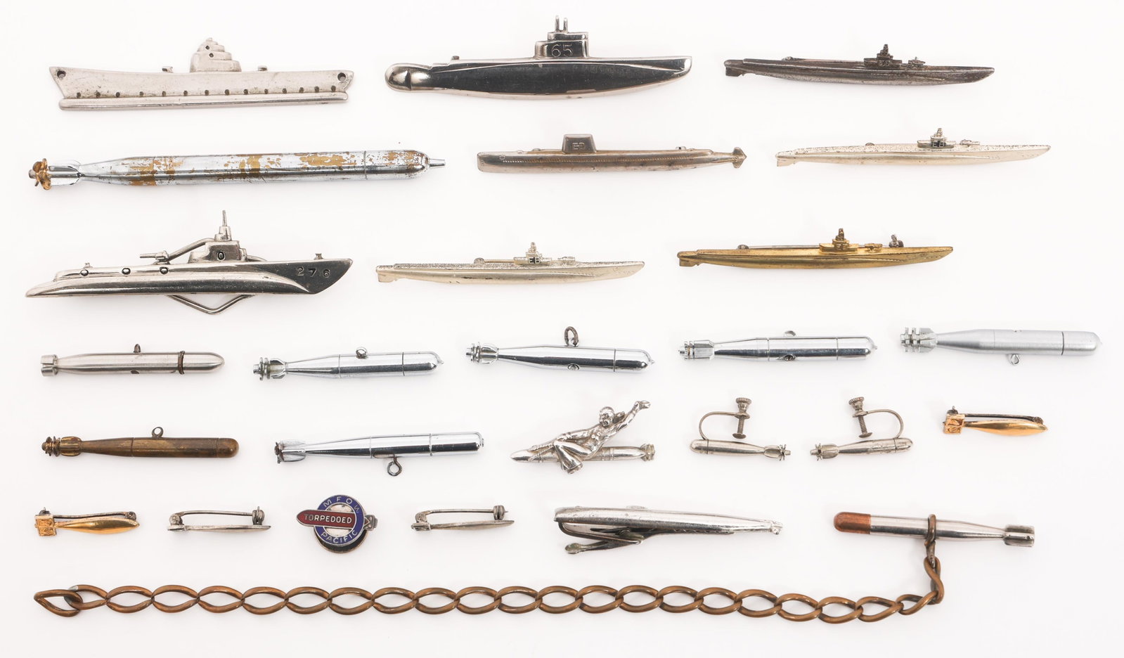 WWII USMC & NAVY TORPEDO INSIGNIA, JEWELRY & PINS: WWII USMC & NAVY TORPEDO INSIGNIA, JEWELRY & PINS WWII US Marine Corps and Navy Torpedo Insignia and Jewelry. Eight marked Sterling. Includes Merchant Marine Torpedo Pin, Torpedo Pins, Charms, Chain, 